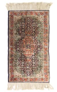 A Silk and Wool Blend Rug 4 feet 1/2 inches x 2 feet 1/2 inches.