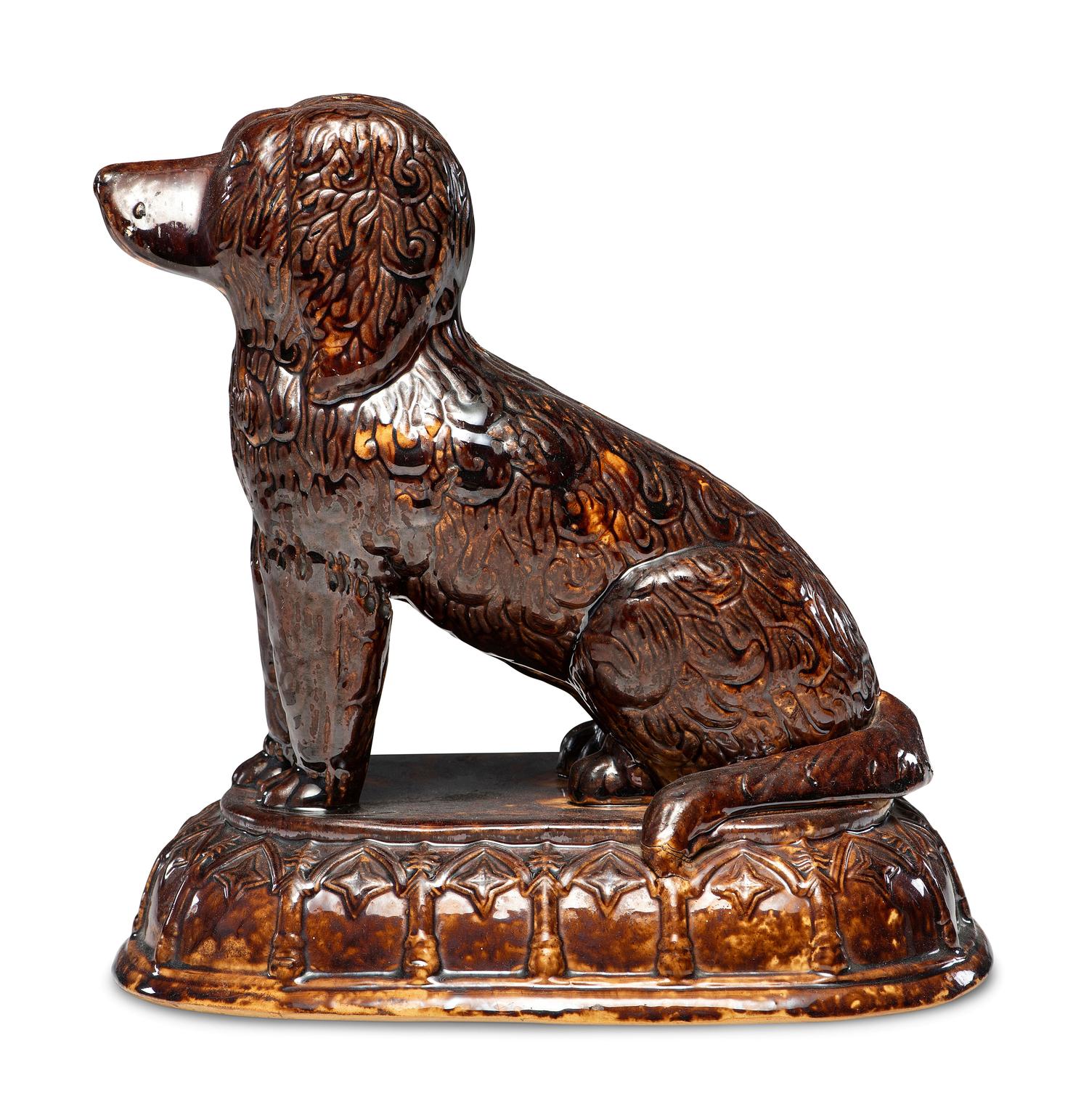A Rare Rockingham Glazed Molded Yelloware Forward-Facing Dog