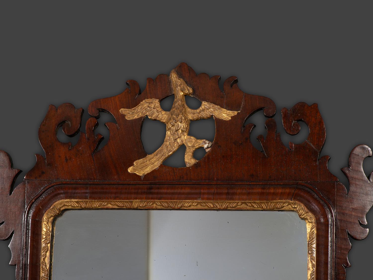 A Chippendale Carved and Parcel Gilt Mahogany Eagle-Decorated Looking Glass