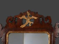 A Chippendale Carved and Parcel Gilt Mahogany Eagle-Decorated Looking Glass