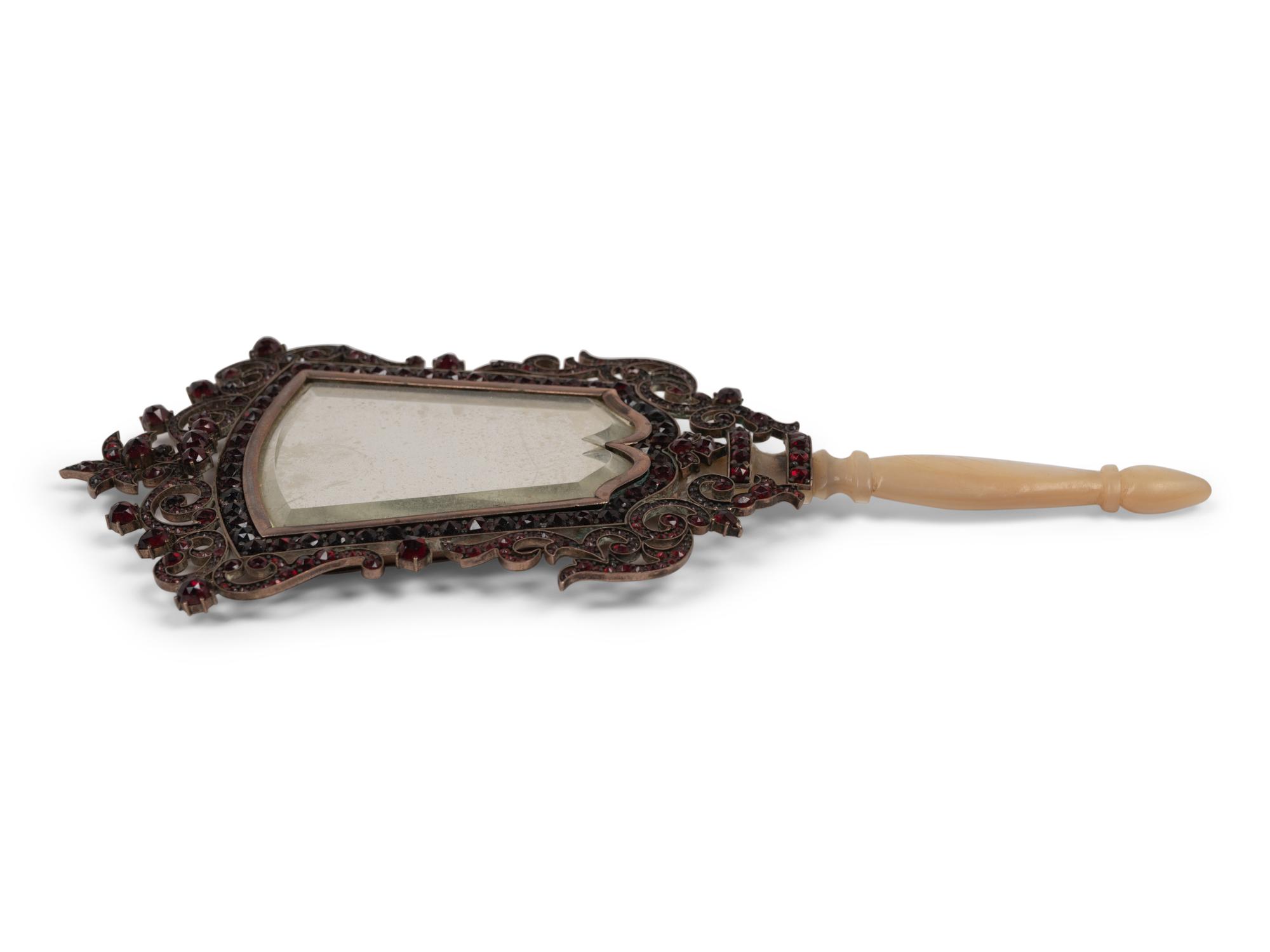 A Continental Mother-of-Pearl Handled Garnet-Inset Mirror