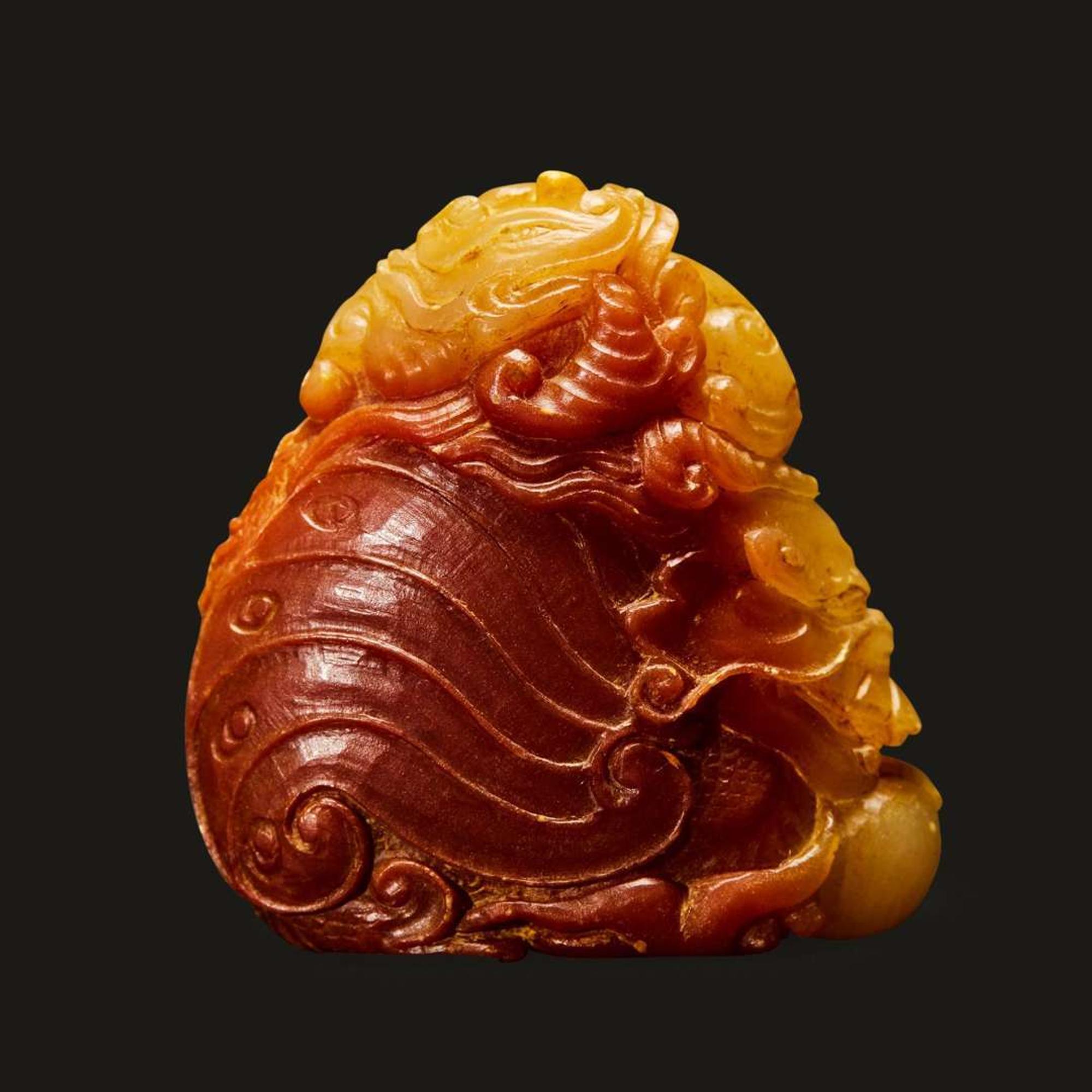 A finely-carved Chinese small yellow and russet soapstone dragon-fish, qilong, and pearl group 壽山石雕小把件