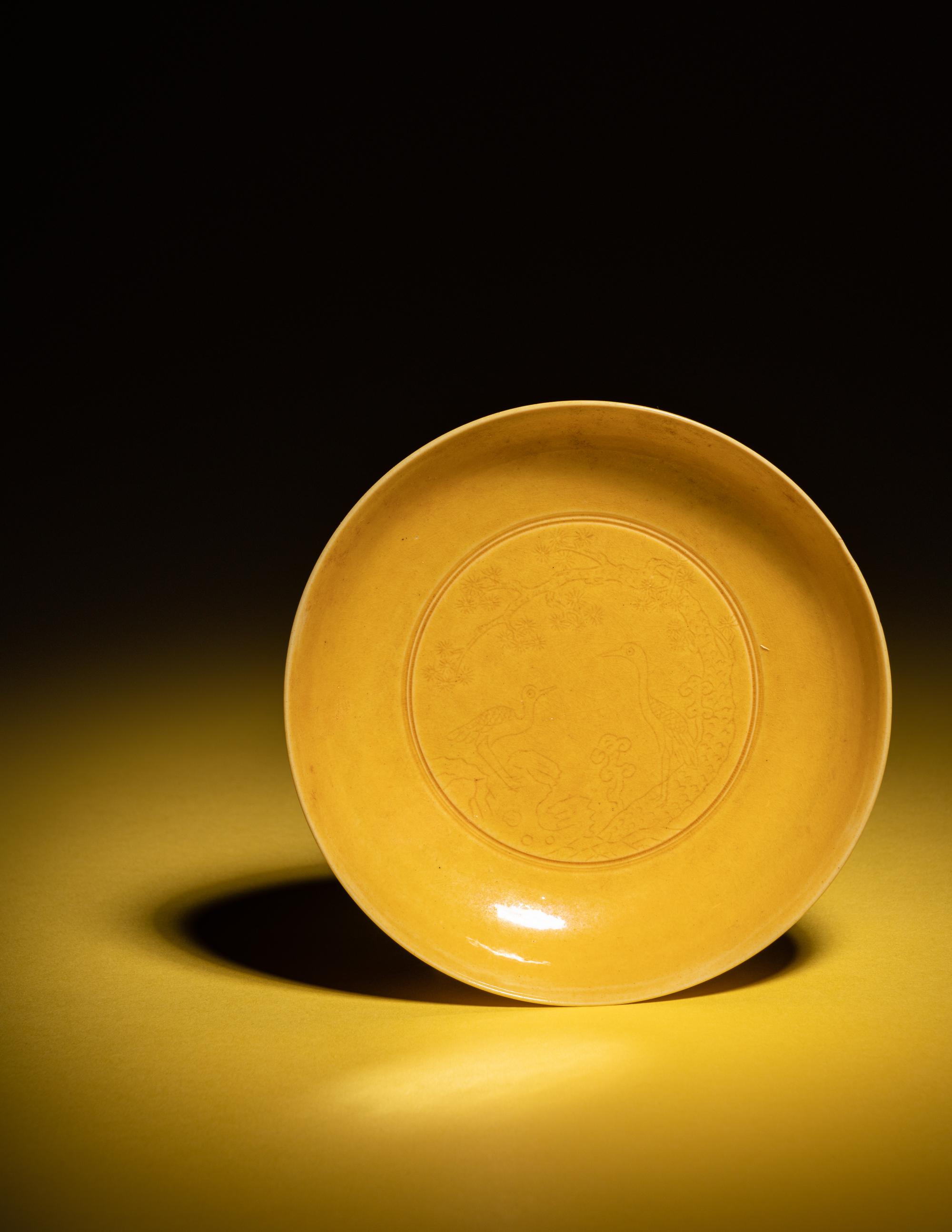 An Incised Yellow Glazed Porcelain 'Cranes and Pines' Plate