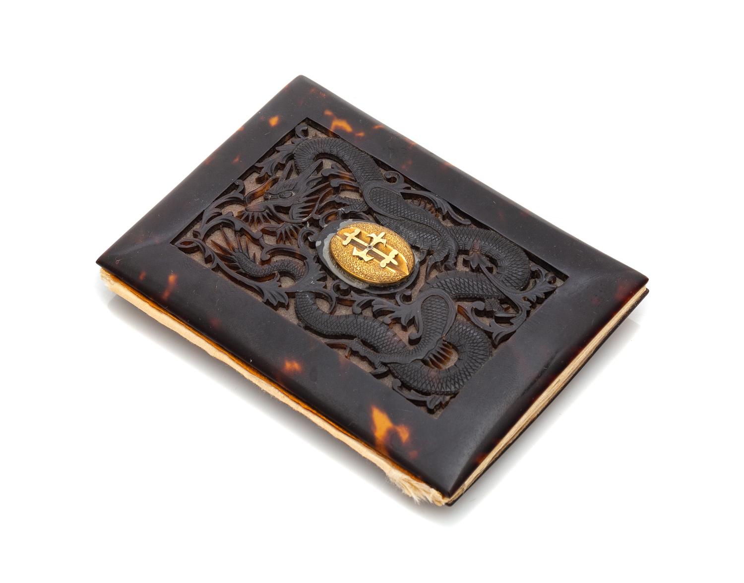 A Japanese Gilt Metal Mounted Carved Tortoise Shell Wallet Width 4 1/8 inches. — LATE 19TH/EARLY 20TH CENTURY