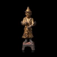 A Chinese Gilt and Lacquered Metal Figure of an Attendant, Ming Dynasty — 明 銅漆金文官像