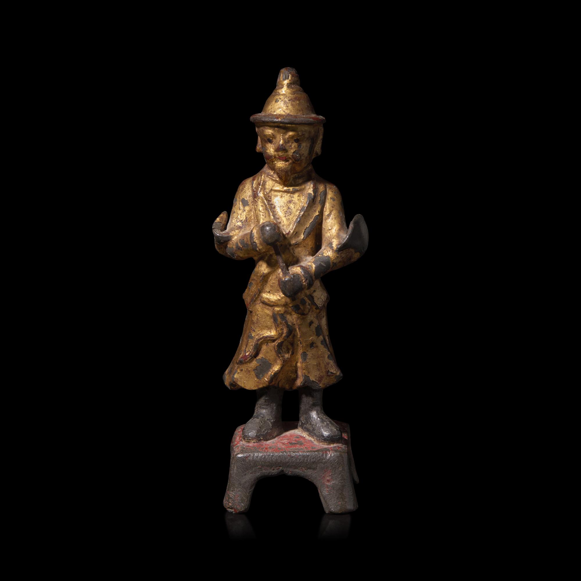 A Chinese Gilt and Lacquered Metal Figure of an Attendant, Ming Dynasty — 明 銅漆金文官像