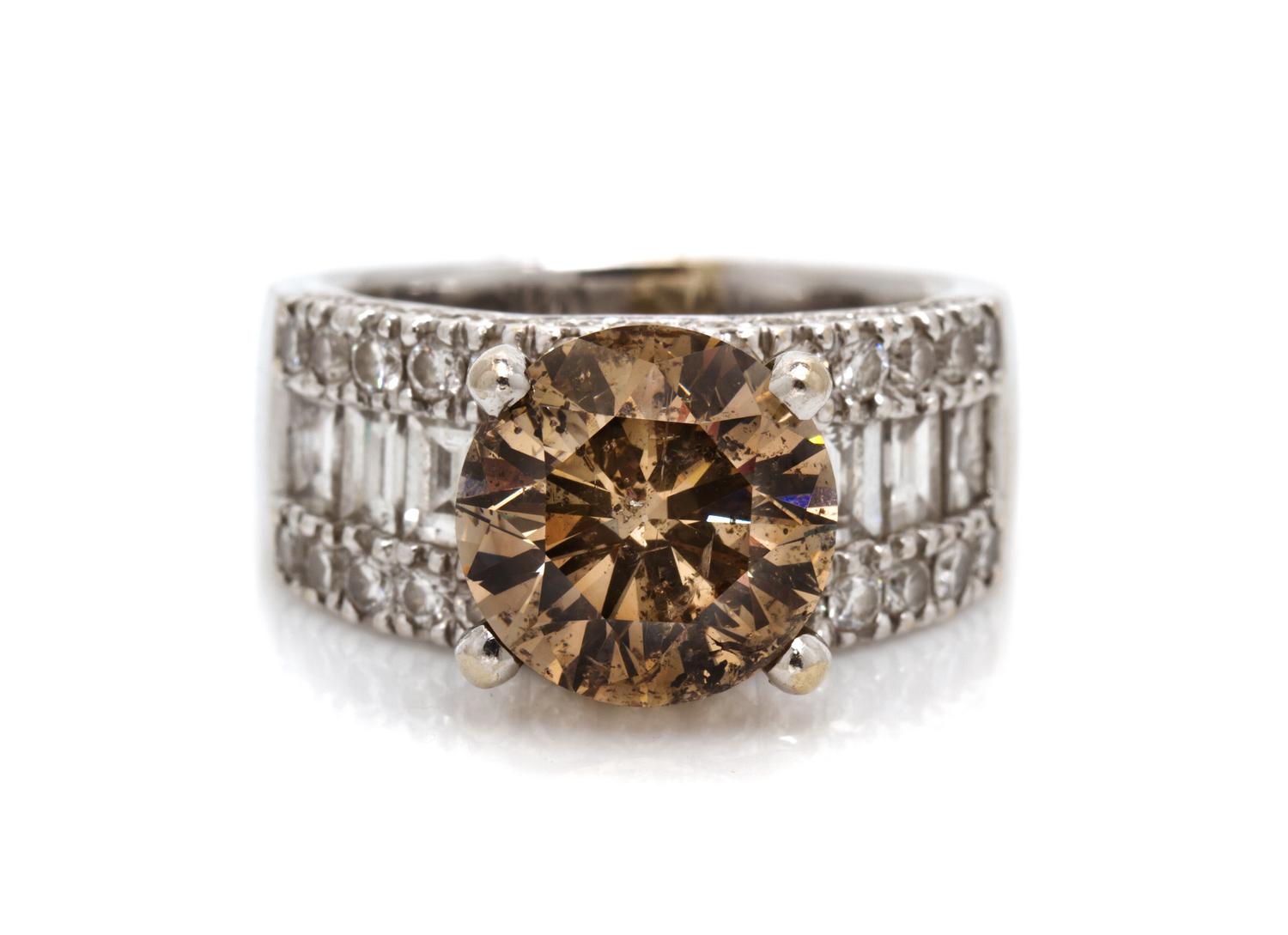 An 18 Karat White Gold, Fancy Colored Diamond and Diamond Ring, 7.90 dwts.