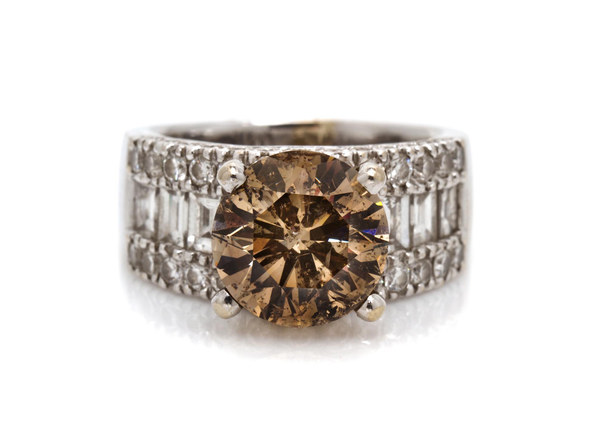 An 18 Karat White Gold, Fancy Colored Diamond and Diamond Ring, 7.90 dwts.