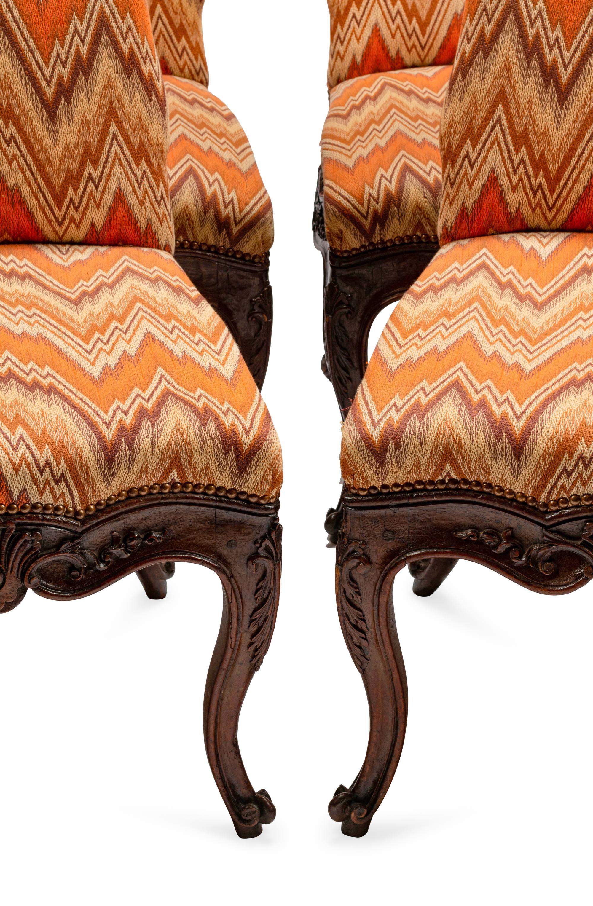A Set of Eight Continental Carved Walnut Dining Chairs