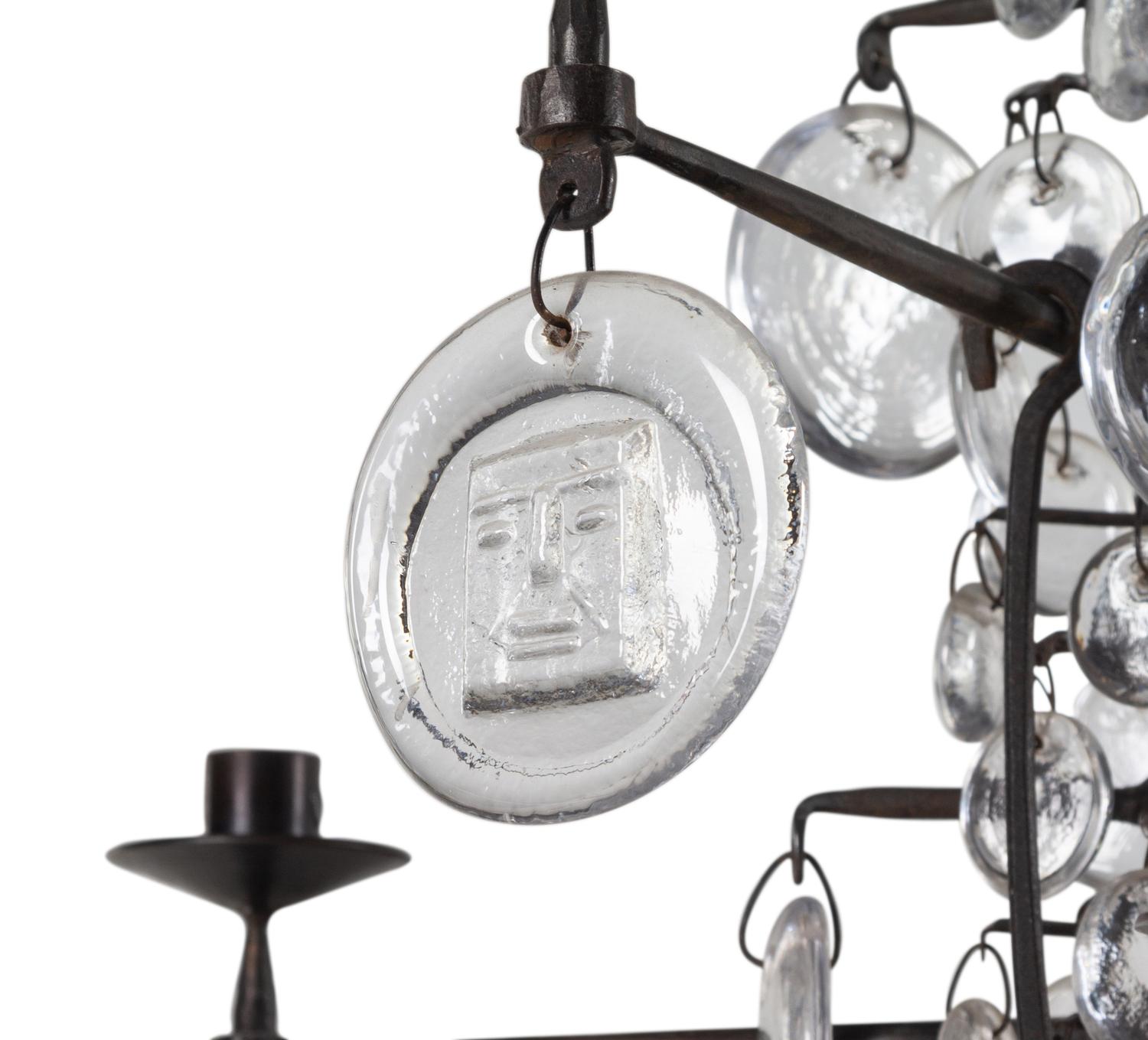 A Swedish Wrought Iron and Molded Glass Twelve-Light Chandelier