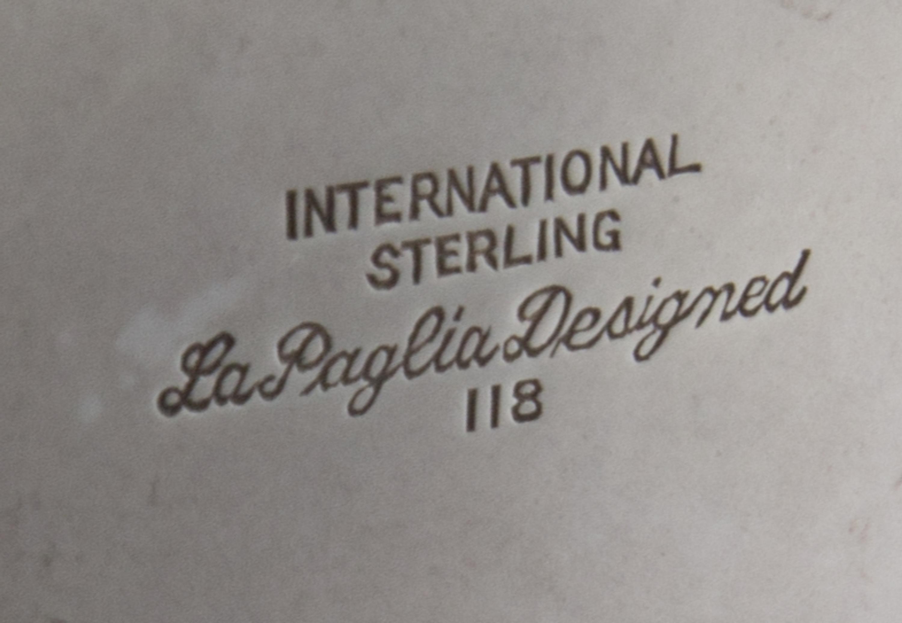 An American Silver Water Pitcher, Alphonse LaPaglia for International Silver Co., Meriden, CT, Mid-20th Century, the scrolled handle wi