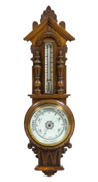 An English Carved Oak Aneroid Barometer, Height 35 inches.