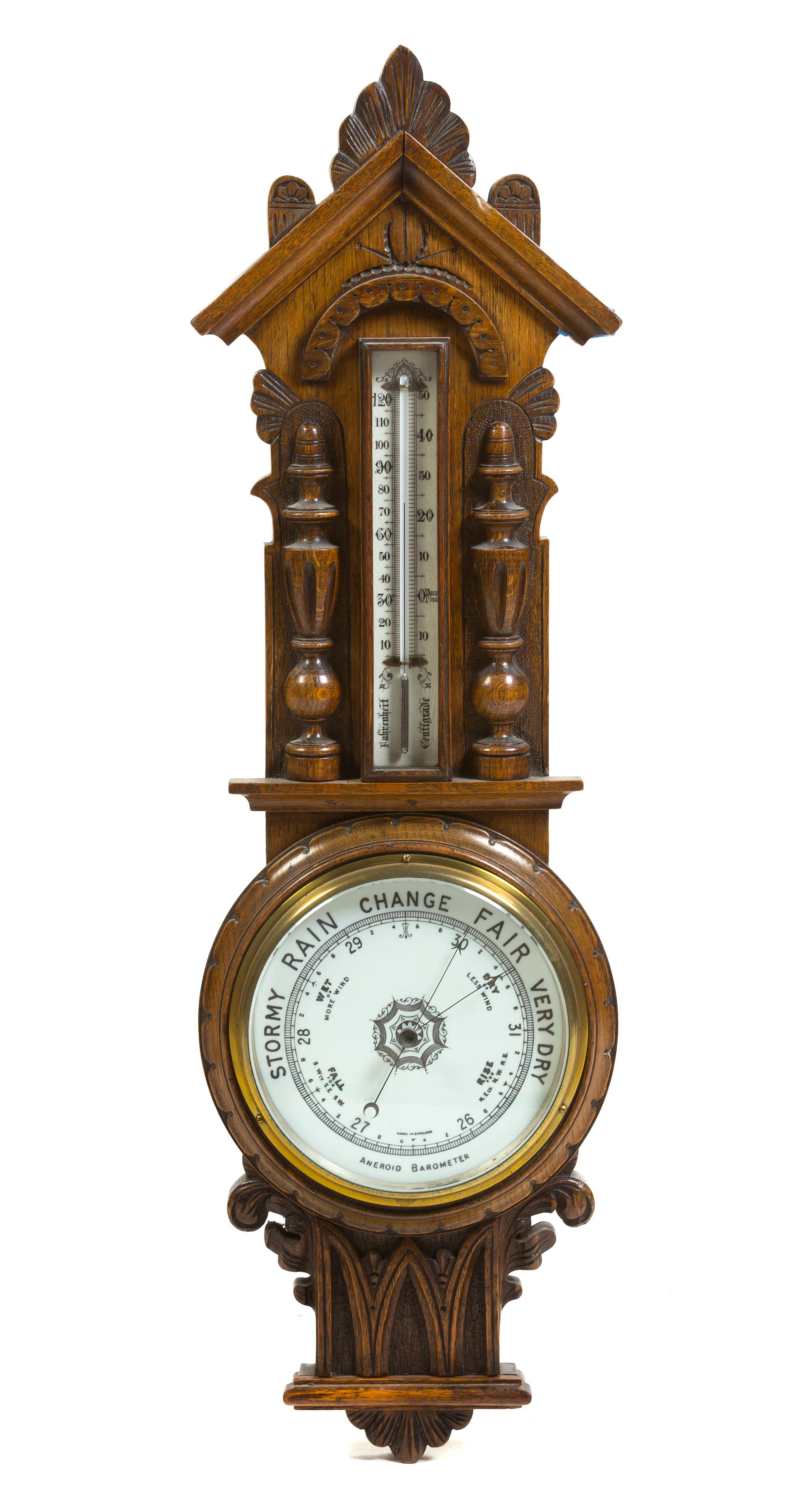 An English Carved Oak Aneroid Barometer, Height 35 inches.