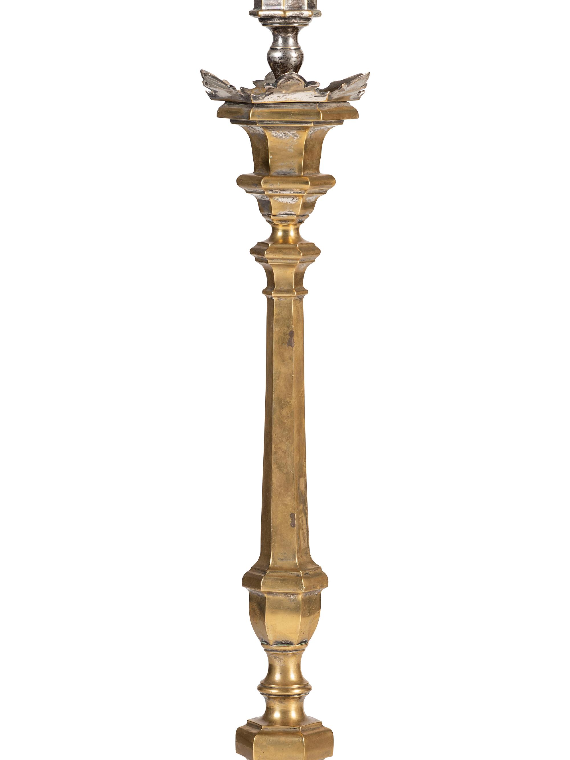A Pair of Continental Baroque Style Silvered Brass Floor Candlestands