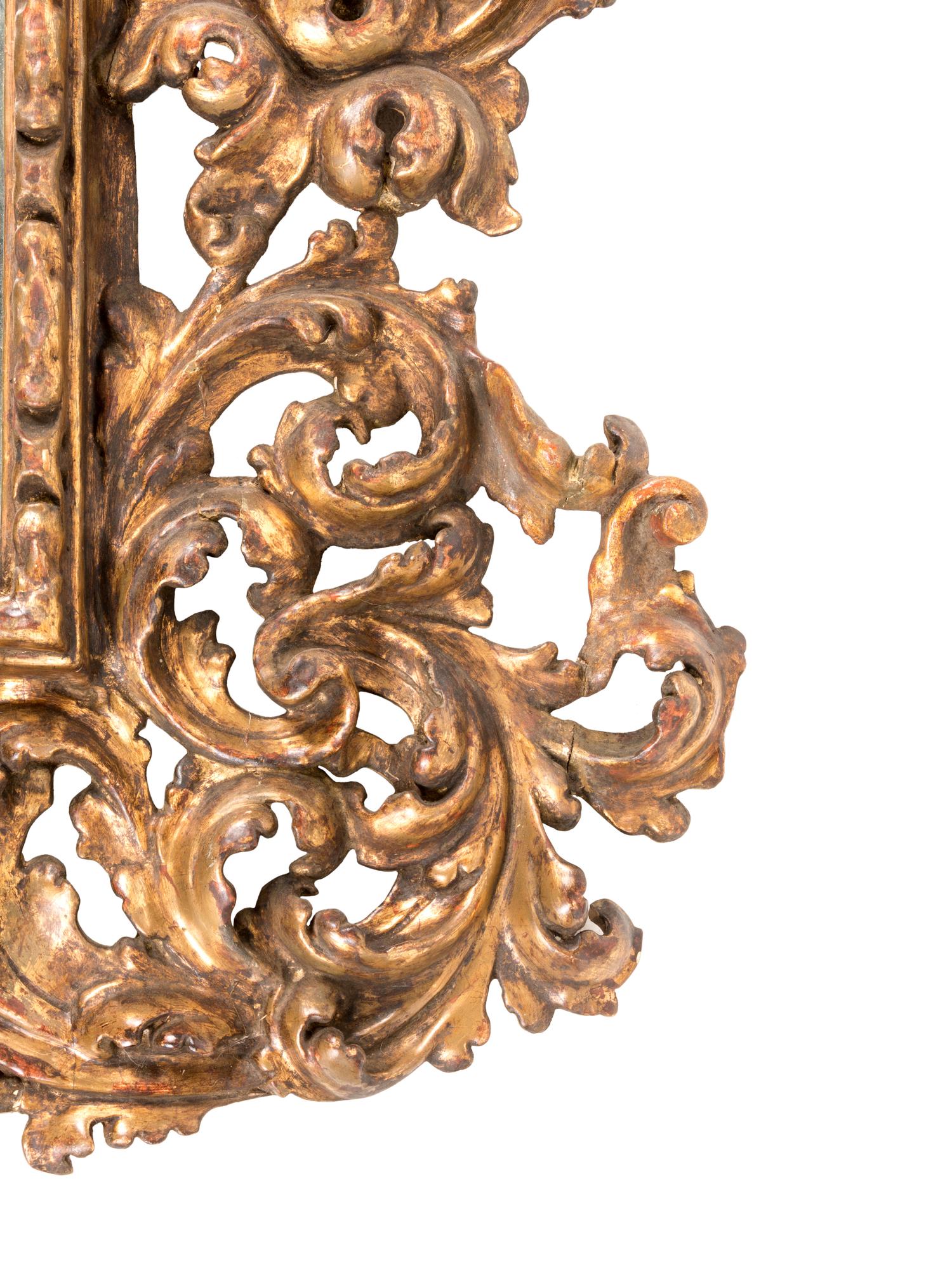 A Florentine Rococo Revival Carved Giltwood Overmantel Mirror