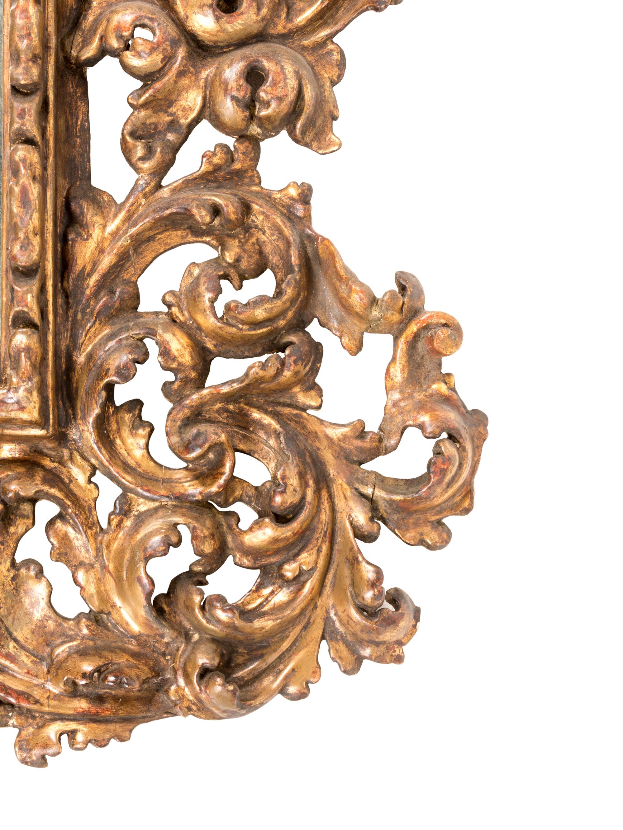 A Florentine Rococo Revival Carved Giltwood Overmantel Mirror