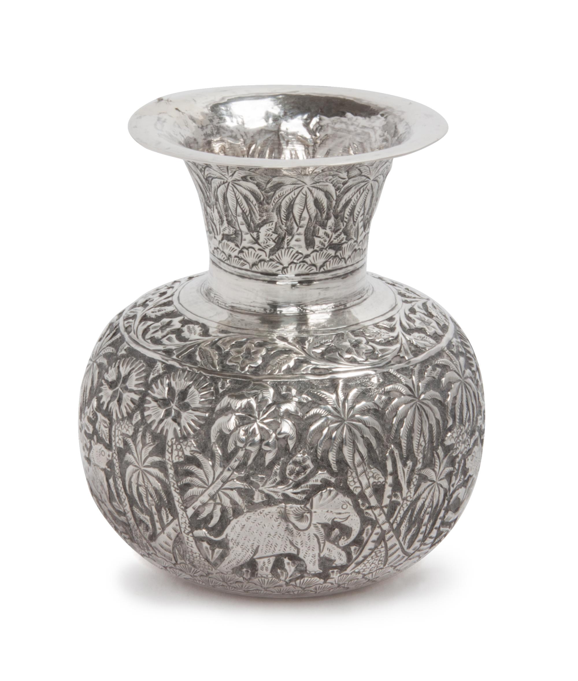A Burmese Silver Vase, , of squat baluster form, worked to show animals in a jungle.