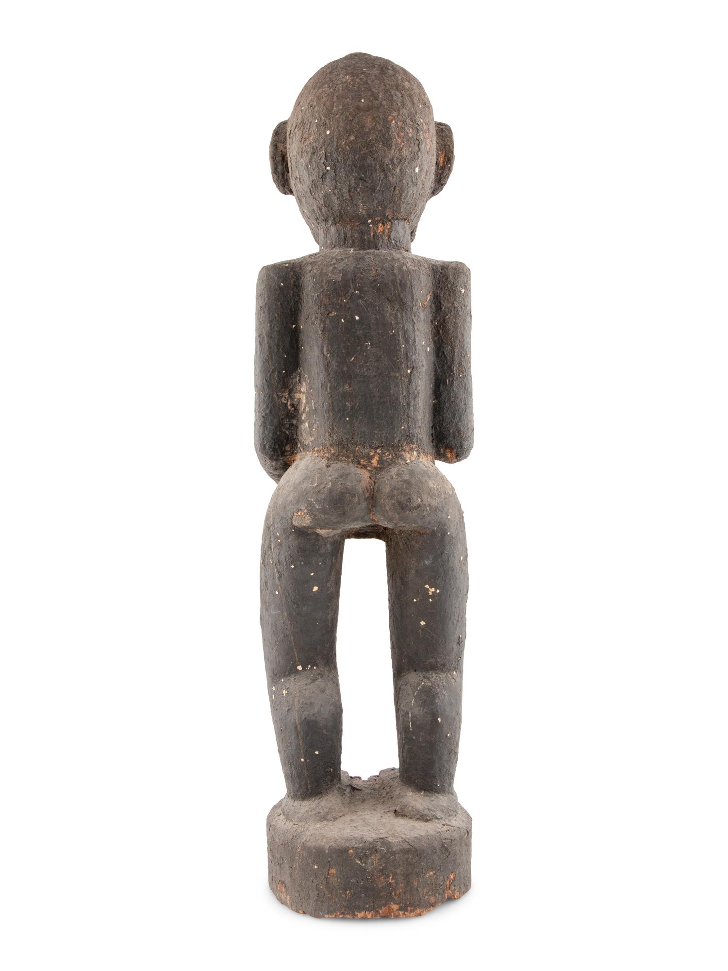 A Carved Wood and Black Painted Monkey Figure