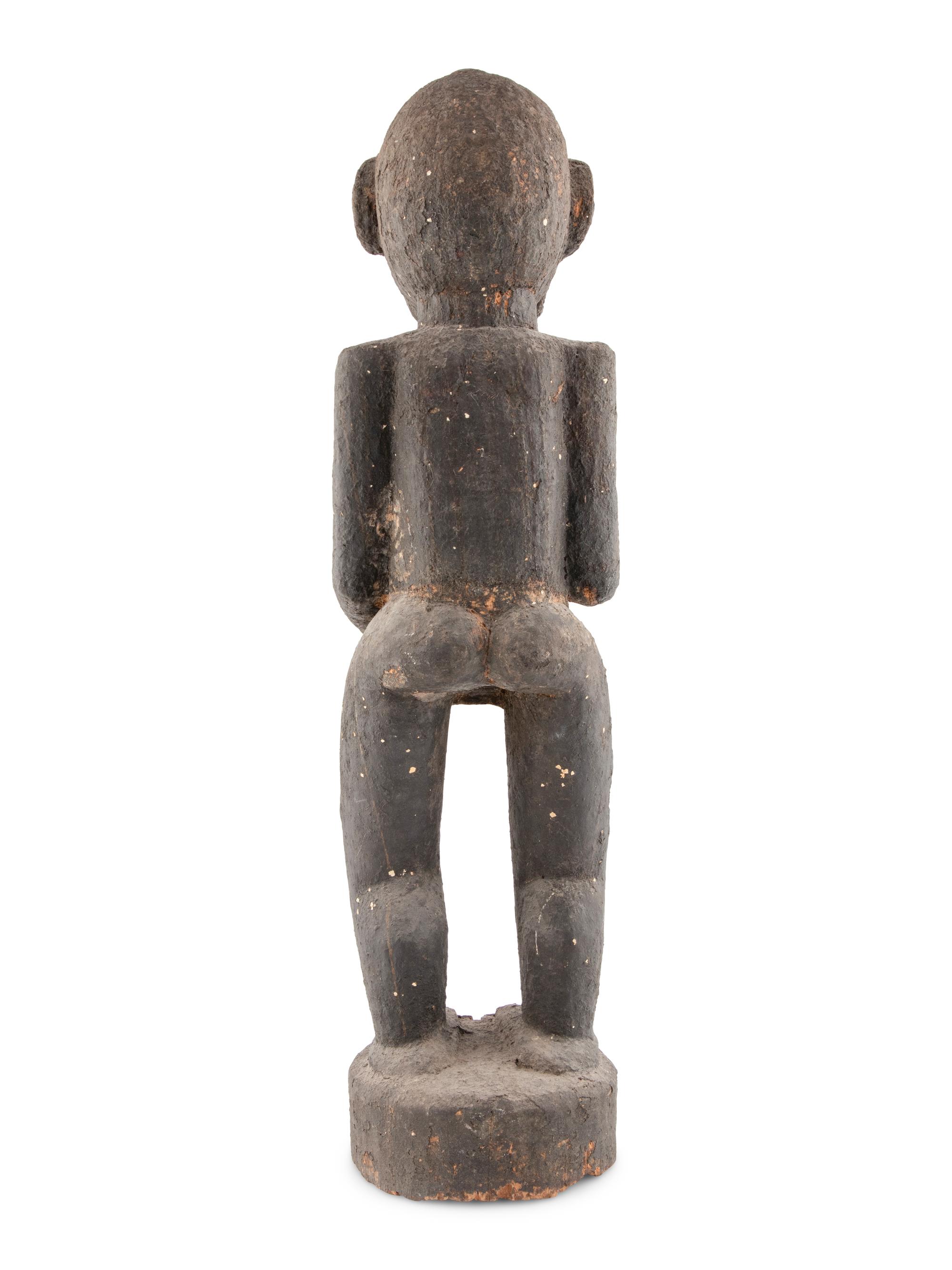 A Carved Wood and Black Painted Monkey Figure