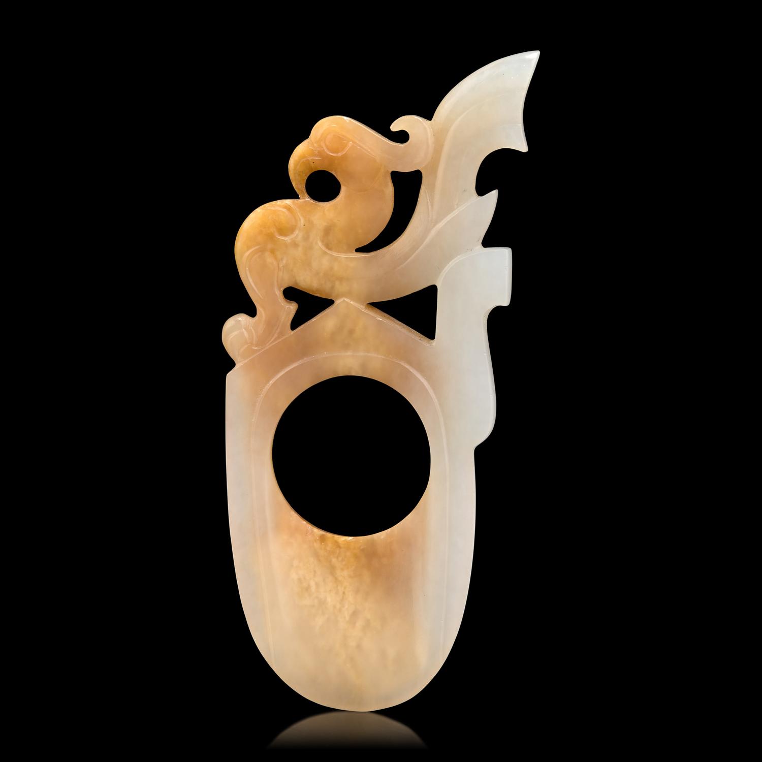 A Chinese Archaistic White and Russet Jade Ring-Form Pendant 白玉鳳紋韘形佩