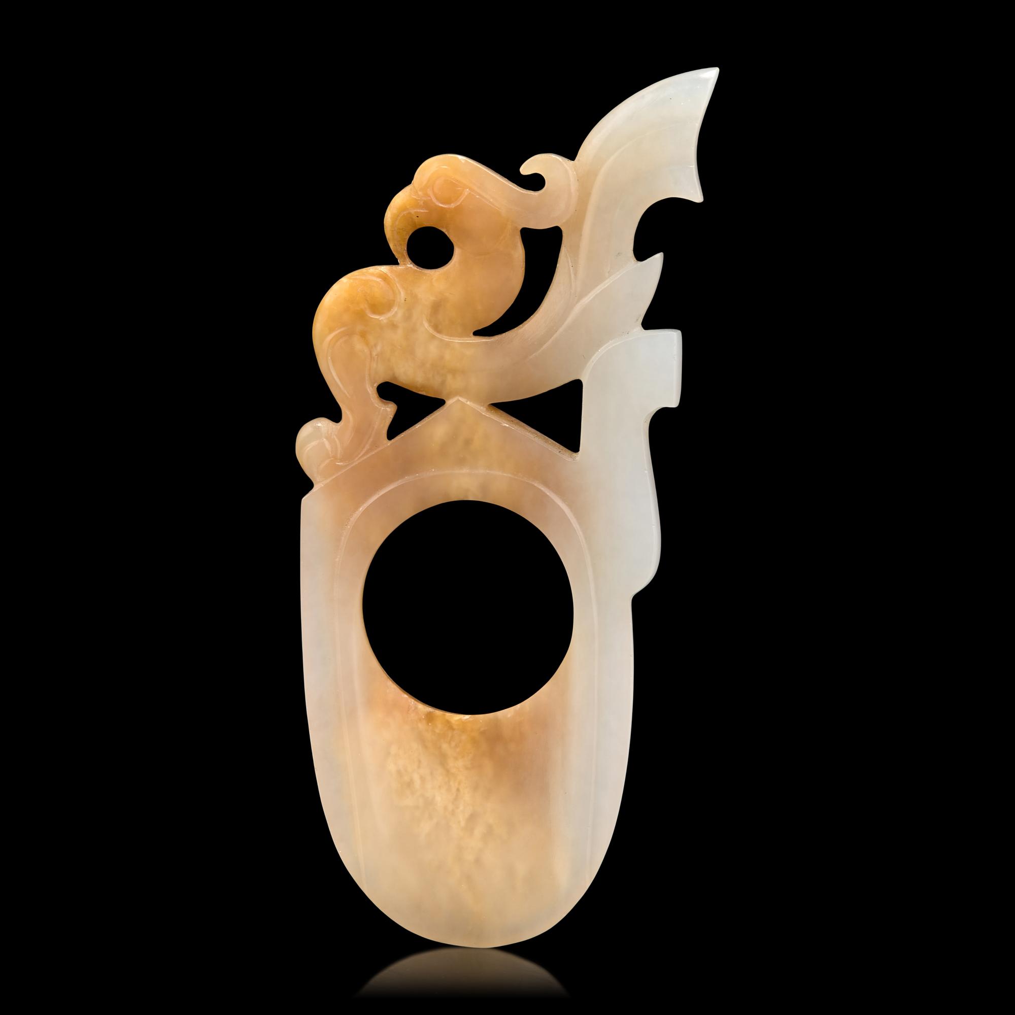 A Chinese Archaistic White and Russet Jade Ring-Form Pendant 白玉鳳紋韘形佩