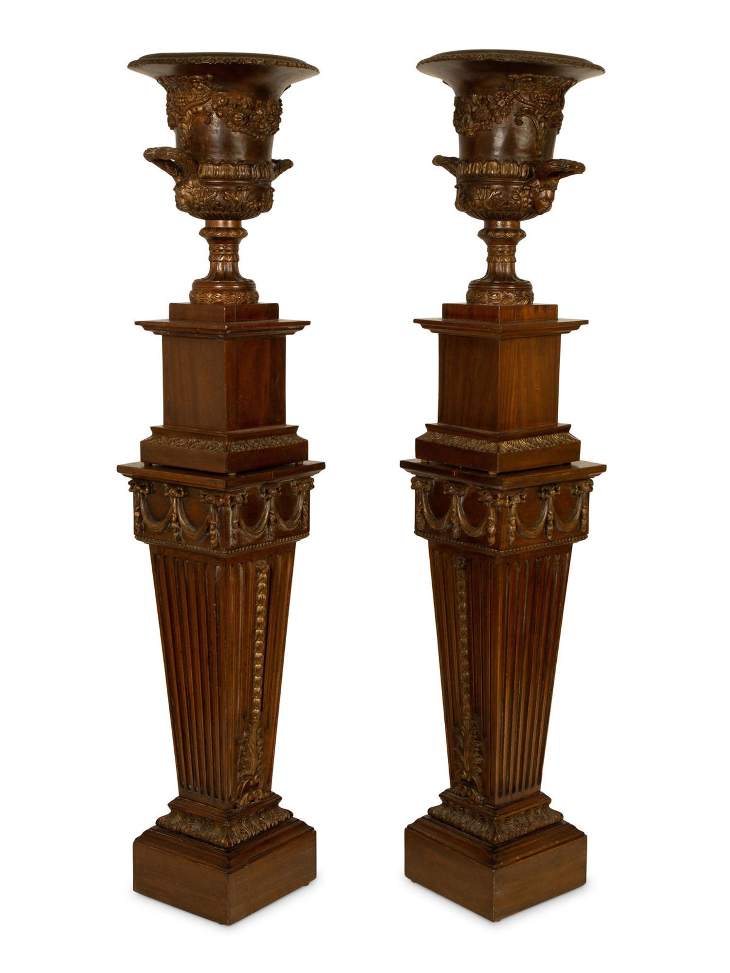 A Pair of George III Style Carved and Stained Wood Campana Urns on Pedestal Stands — 20TH CENTURY