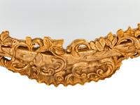 An Italian Rococo Style Carved Giltwood Oval Mirror