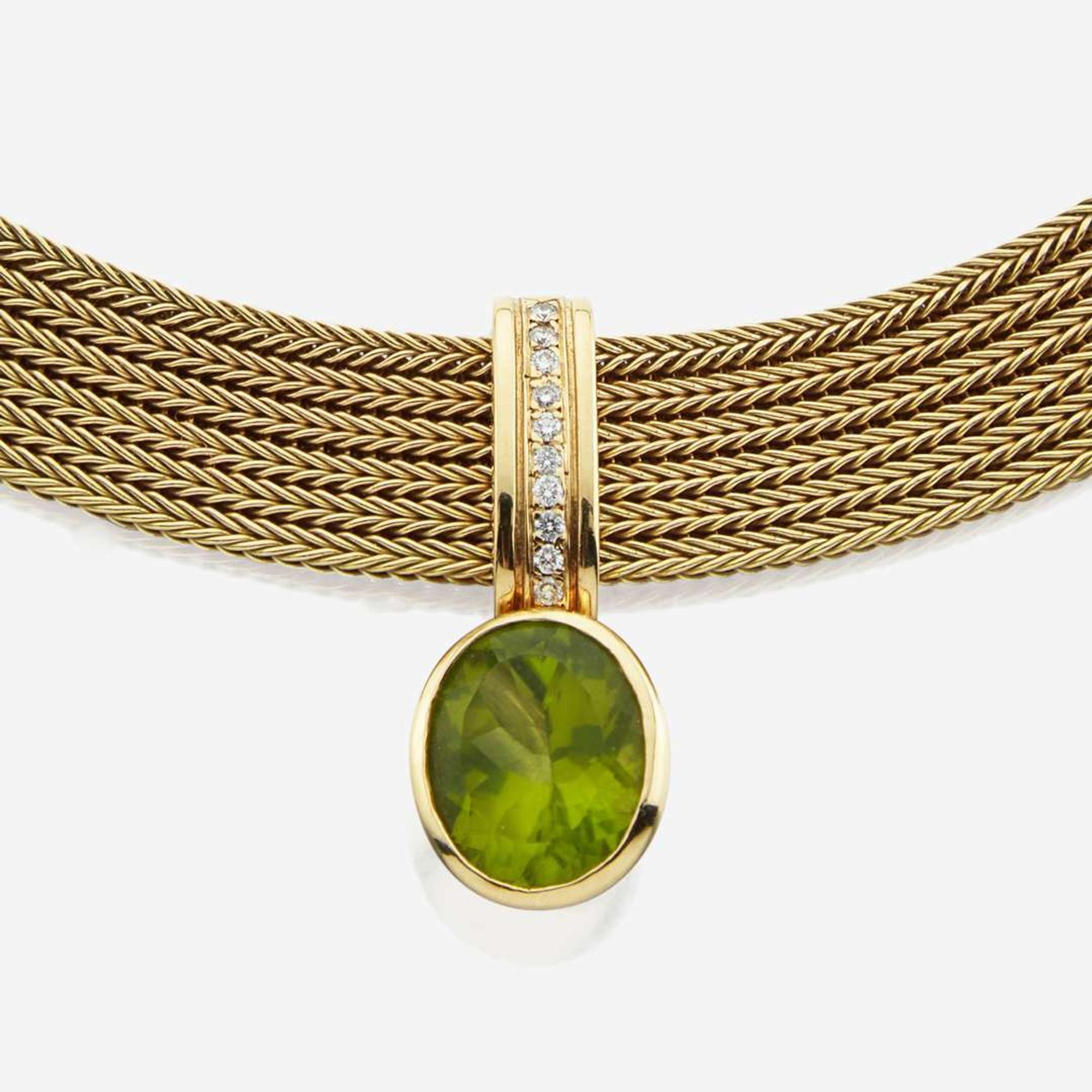 A peridot, diamond, and gold necklace
