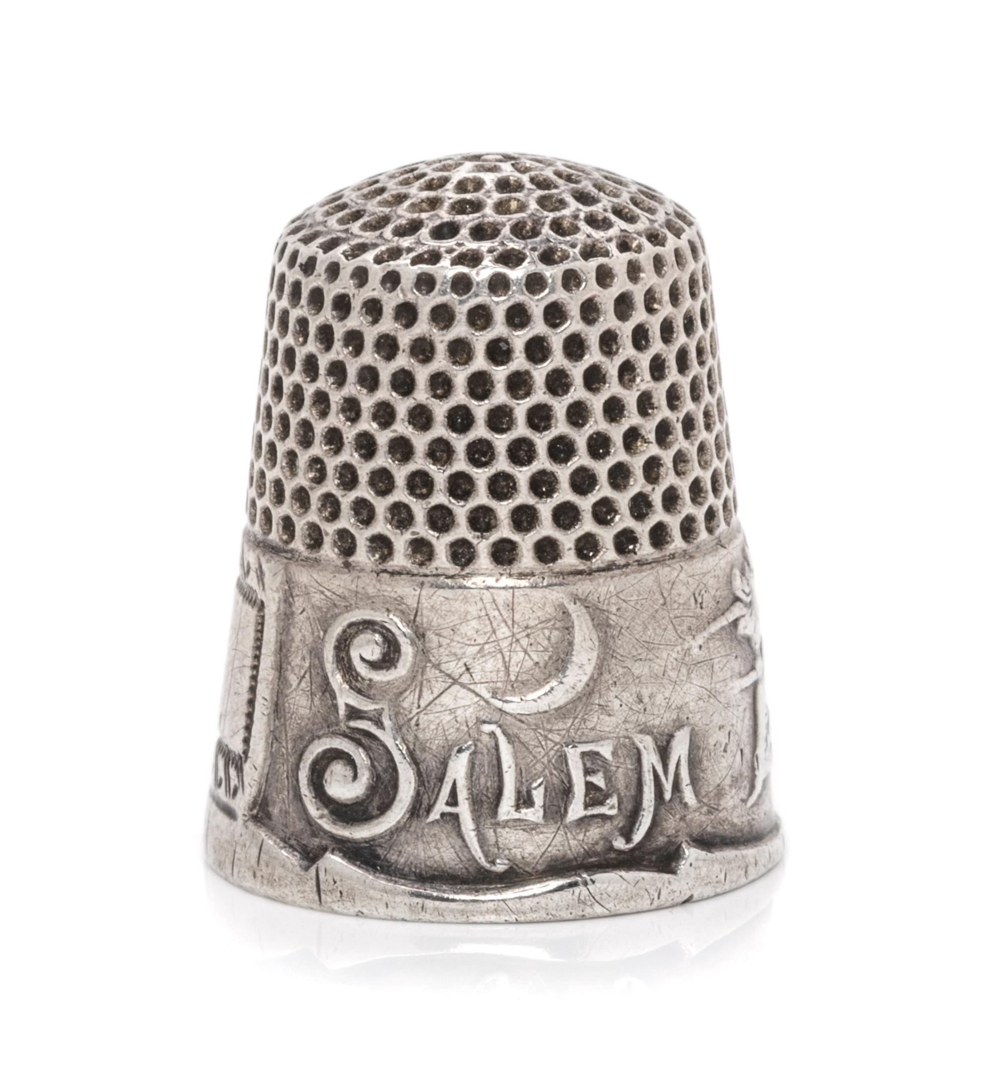 An American Silver Commemorative Thimble, Ketcham & McDougall, New York, NY, the dimpled top and body above a band commemorating the 16