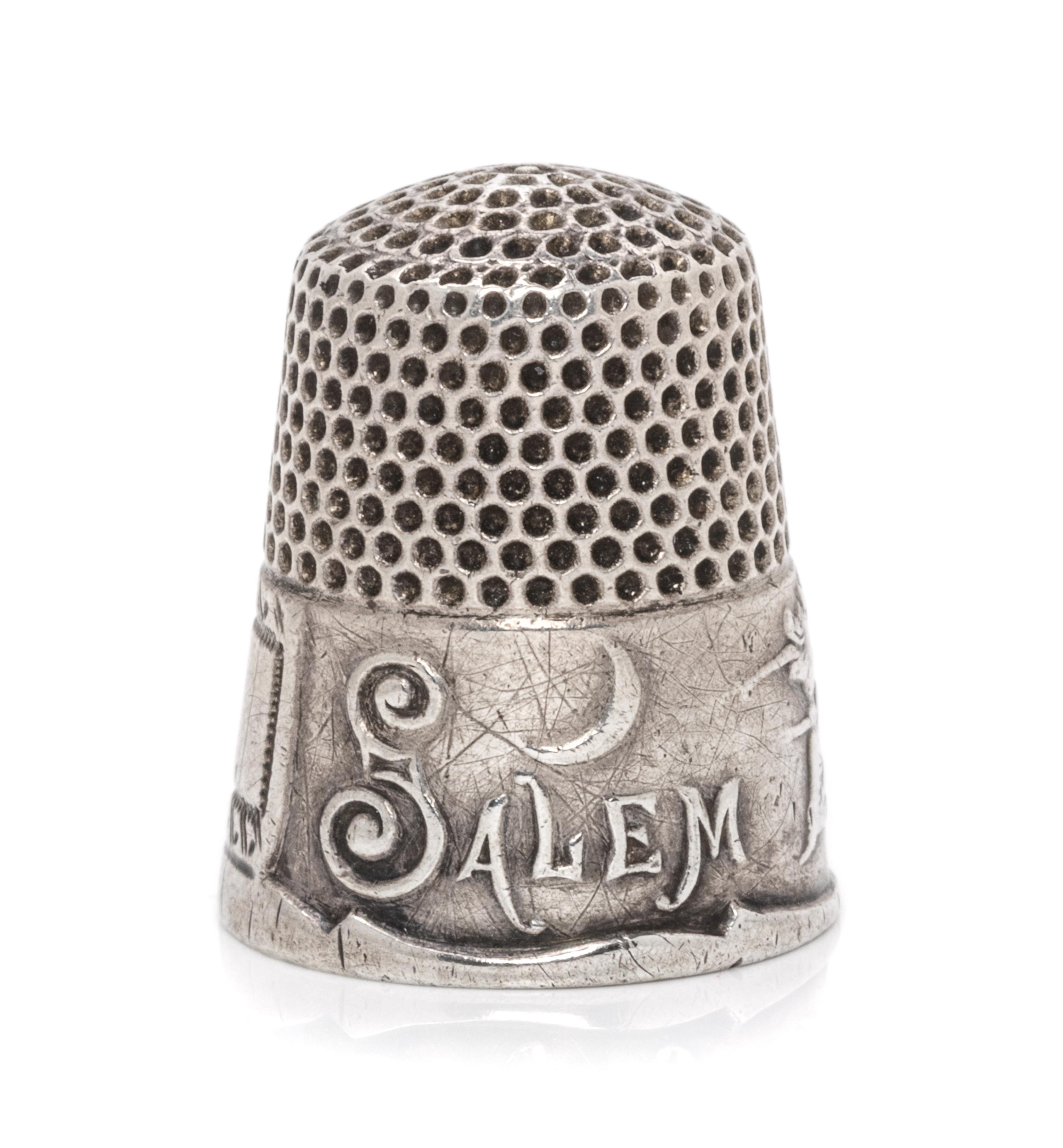 An American Silver Commemorative Thimble, Ketcham & McDougall, New York, NY, the dimpled top and body above a band commemorating the 16