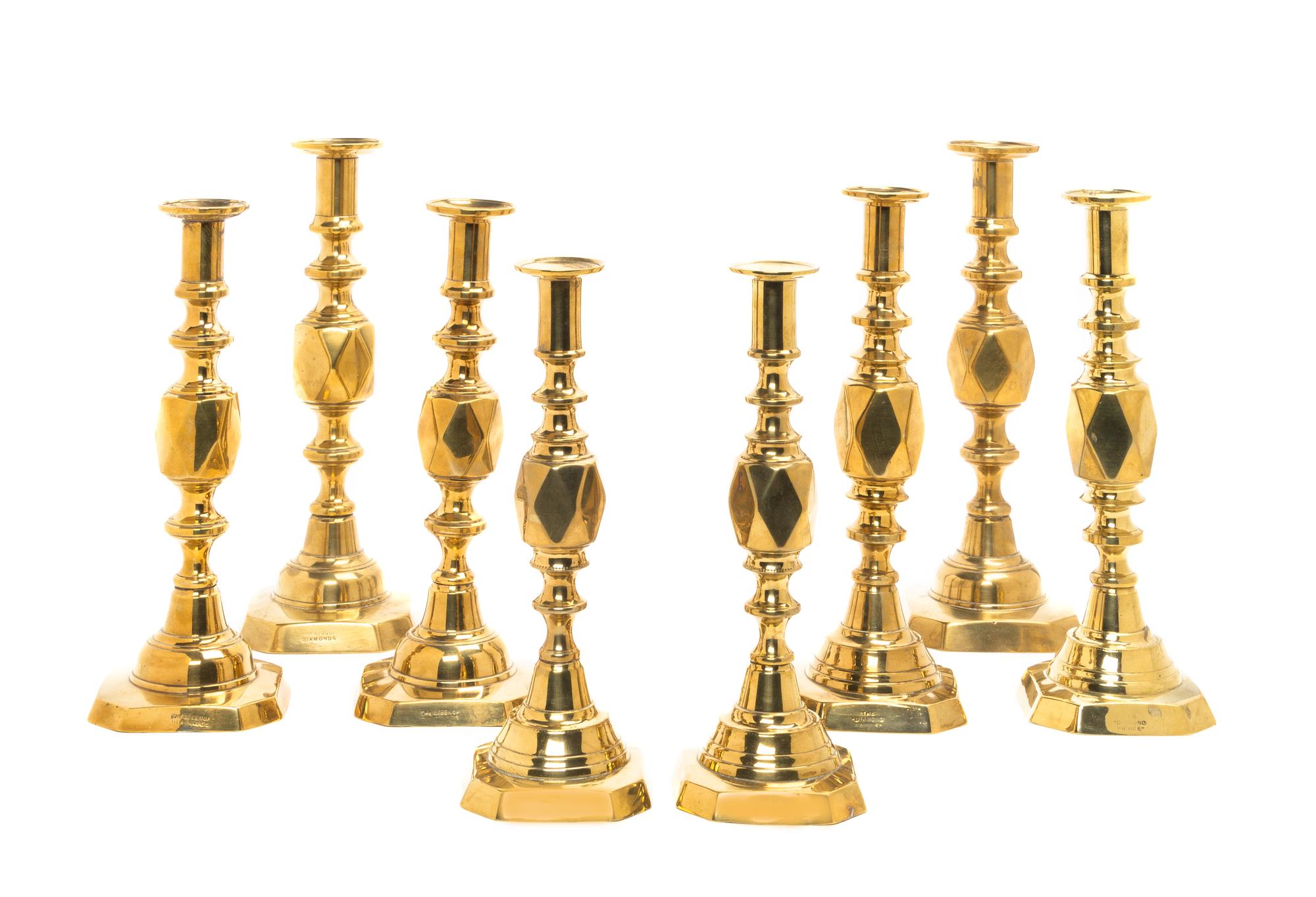 Four Pairs of English Brass Diamond Jubilee Candlesticks, Height of tallest 12 1/2 inches.