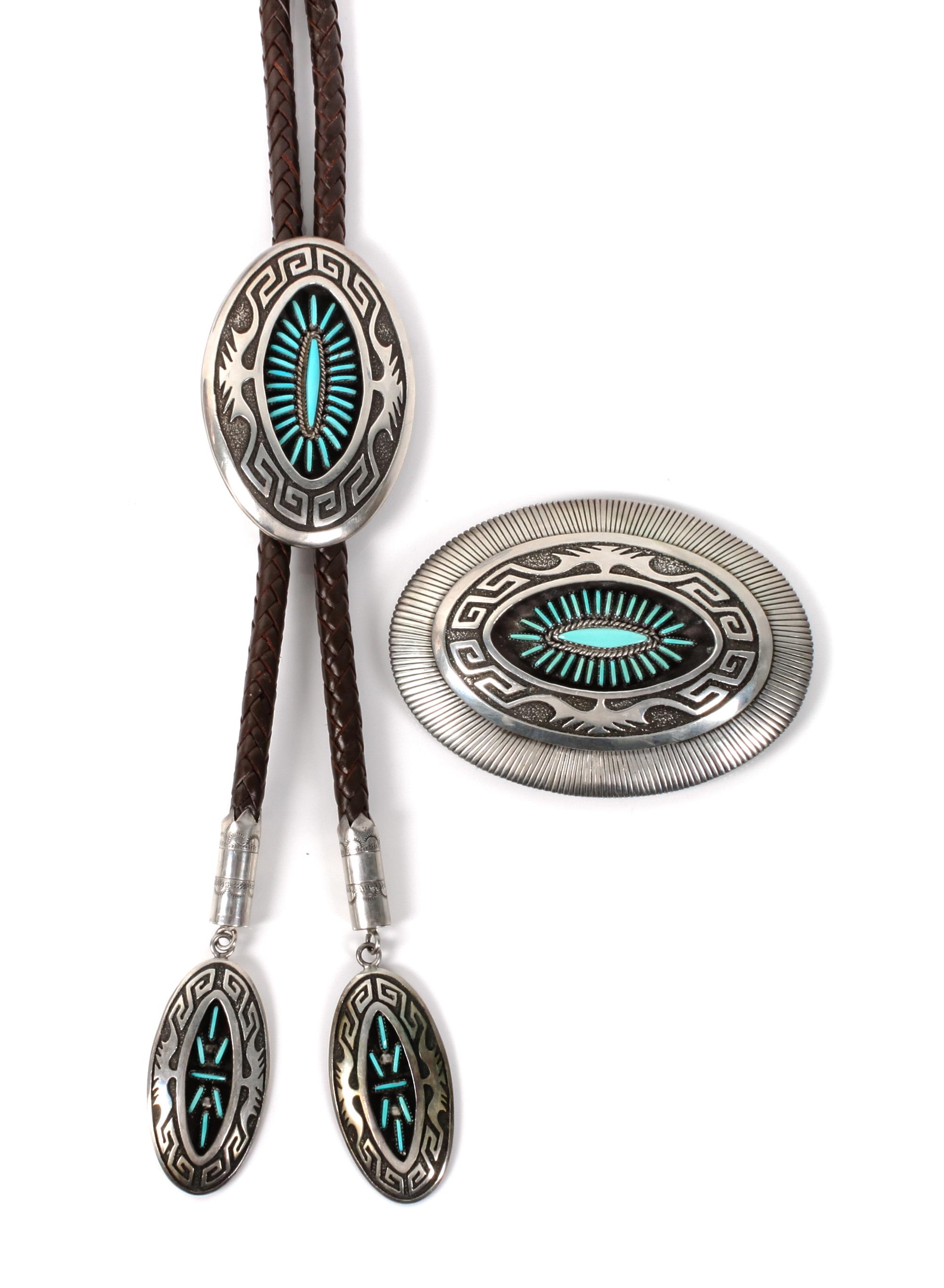 A Navajo Silver and Turquoise Belt Buckle and Matching Bolo, Abraham Begay Height of buckle 2 3/4 x width 3 3/4 inches.