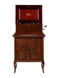 A Mira Mahogany-Cased Disc Music Box and Cabinet
