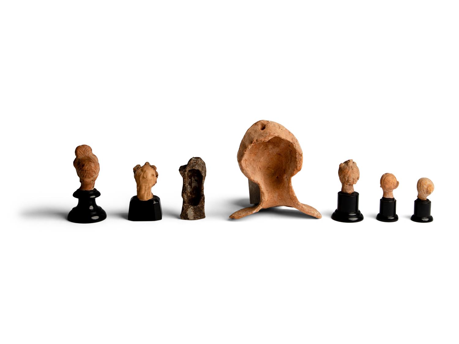 Six Greek Terracotta Heads and One Headless Figure