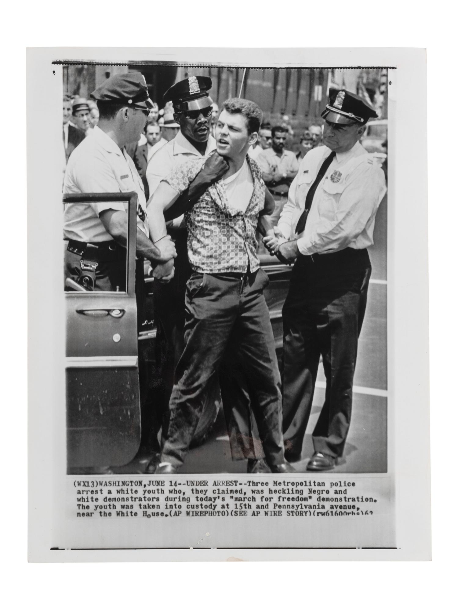 [CIVIL RIGHTS]. Press photograph of Washington, DC, police arresting a white male for purportedly heckling demonstrators during a "march for freedom." Washington, DC, 15 June 1963.