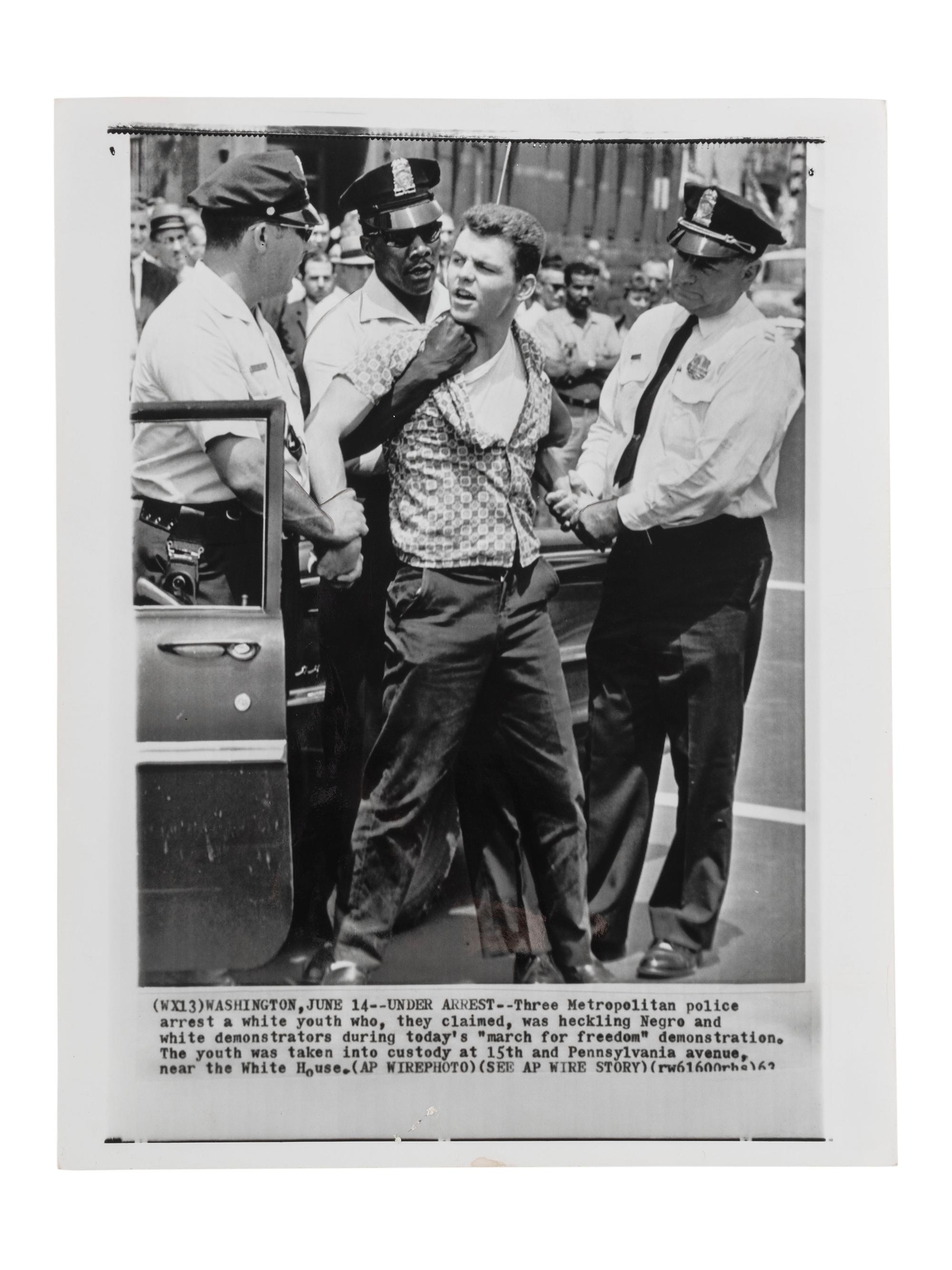[CIVIL RIGHTS]. Press photograph of Washington, DC, police arresting a white male for purportedly heckling demonstrators during a "march for freedom." Washington, DC, 15 June 1963.