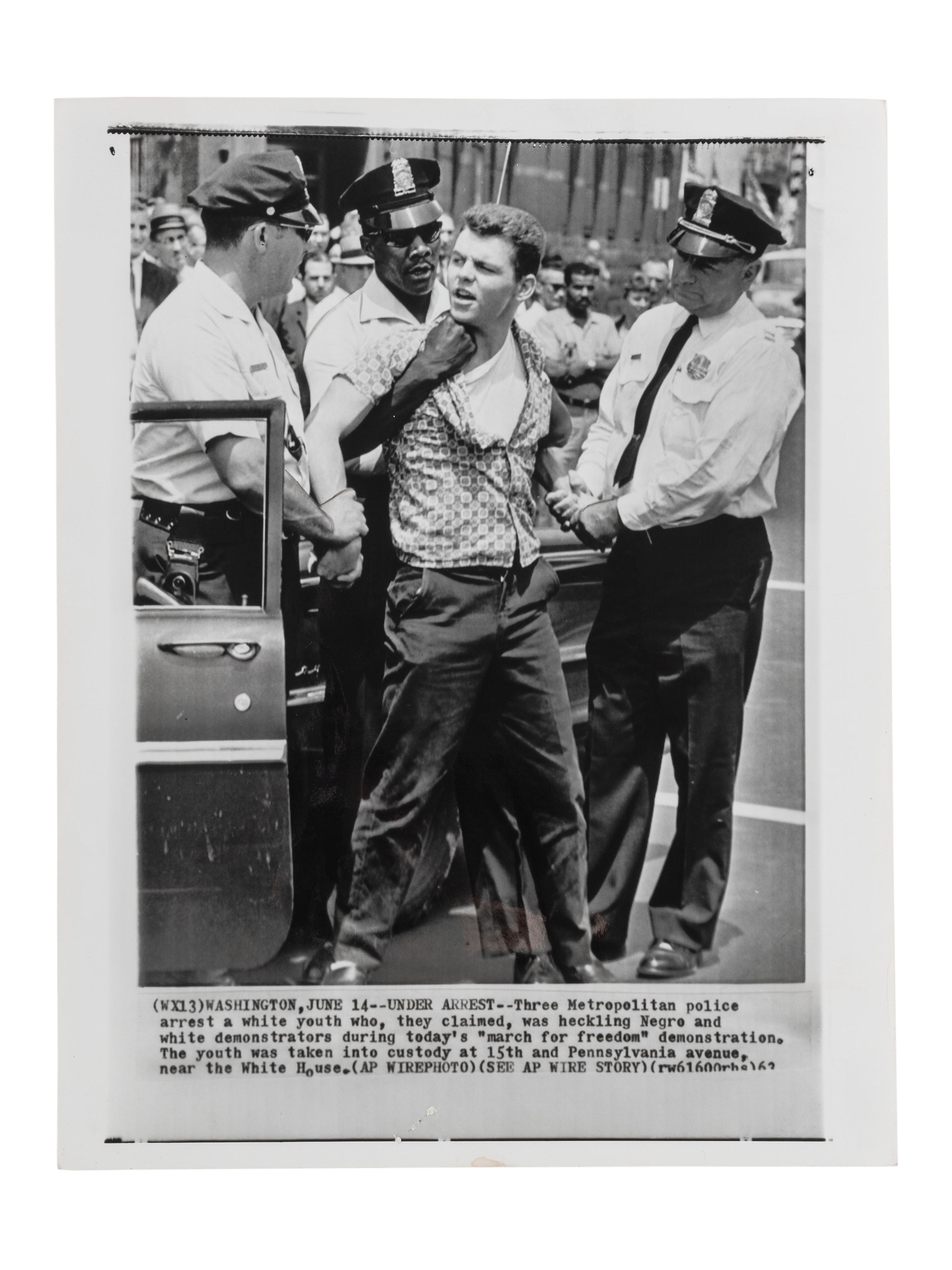 [CIVIL RIGHTS]. Press photograph of Washington, DC, police arresting a white male for purportedly heckling demonstrators during a "march for freedom." Washington, DC, 15 June 1963.