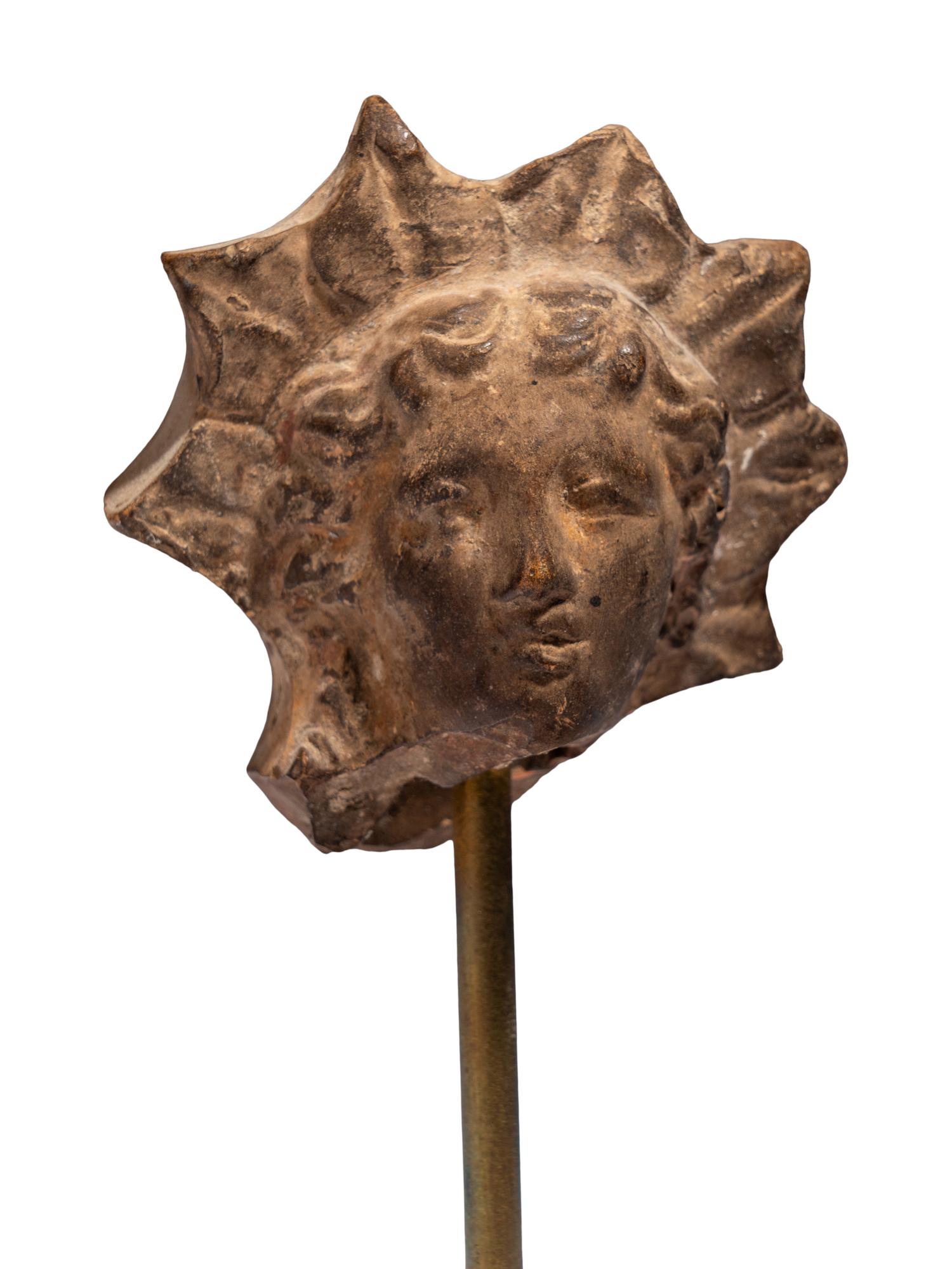 A Greek Terracotta Head of Helios