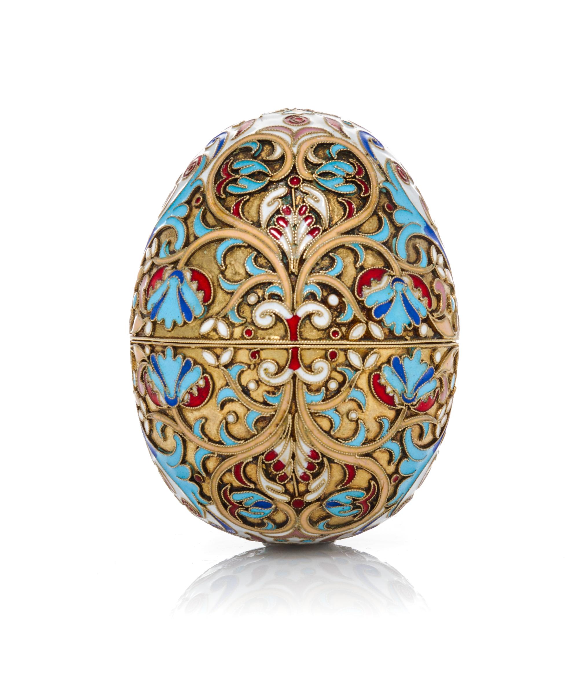 A Russian Enameled Silver Egg, 19th Century, in two parts with floral and foliate decoration.
