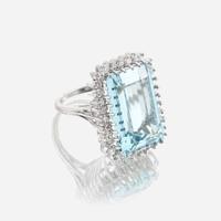 An aquamarine, diamond, and fourteen karat white gold ring