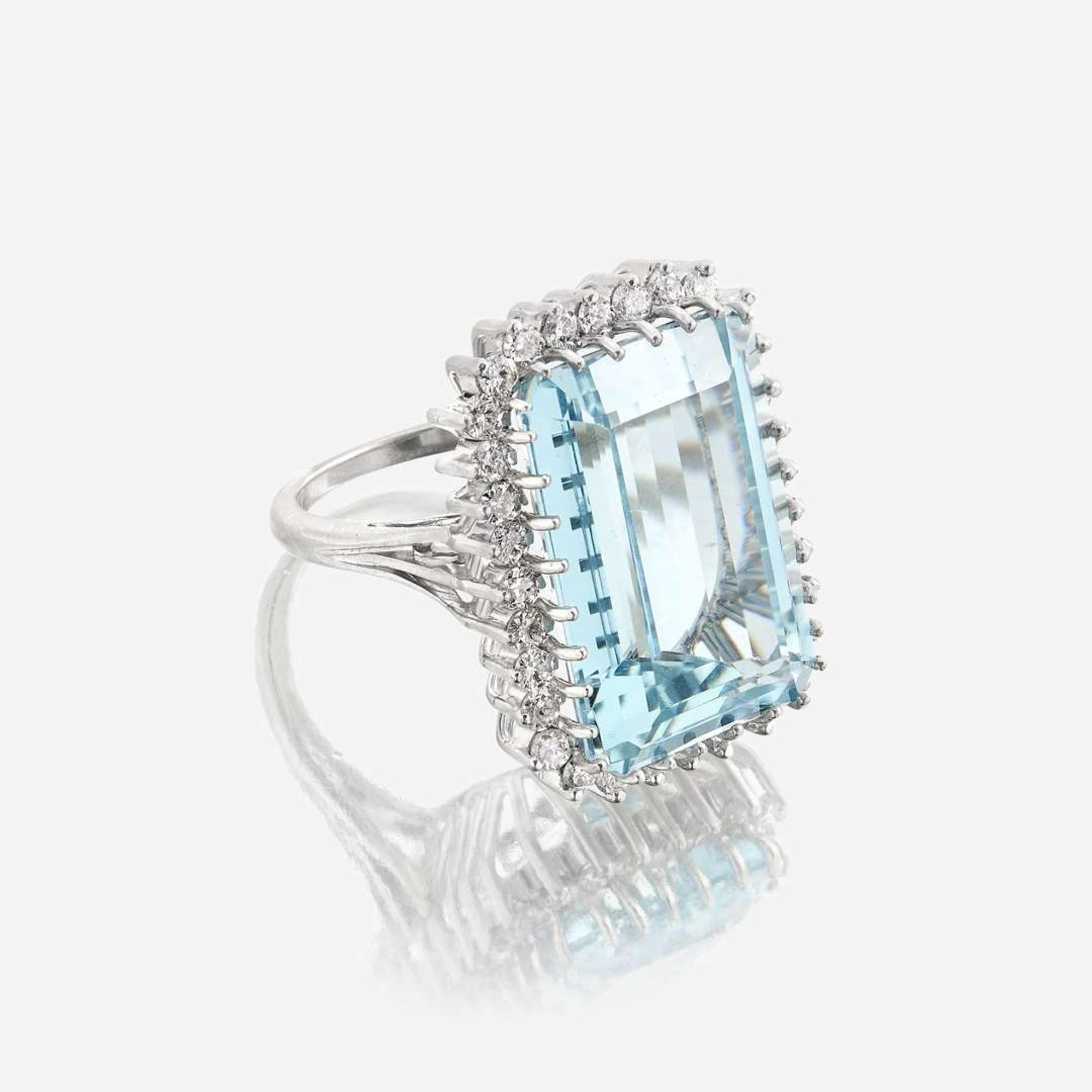 An aquamarine, diamond, and fourteen karat white gold ring