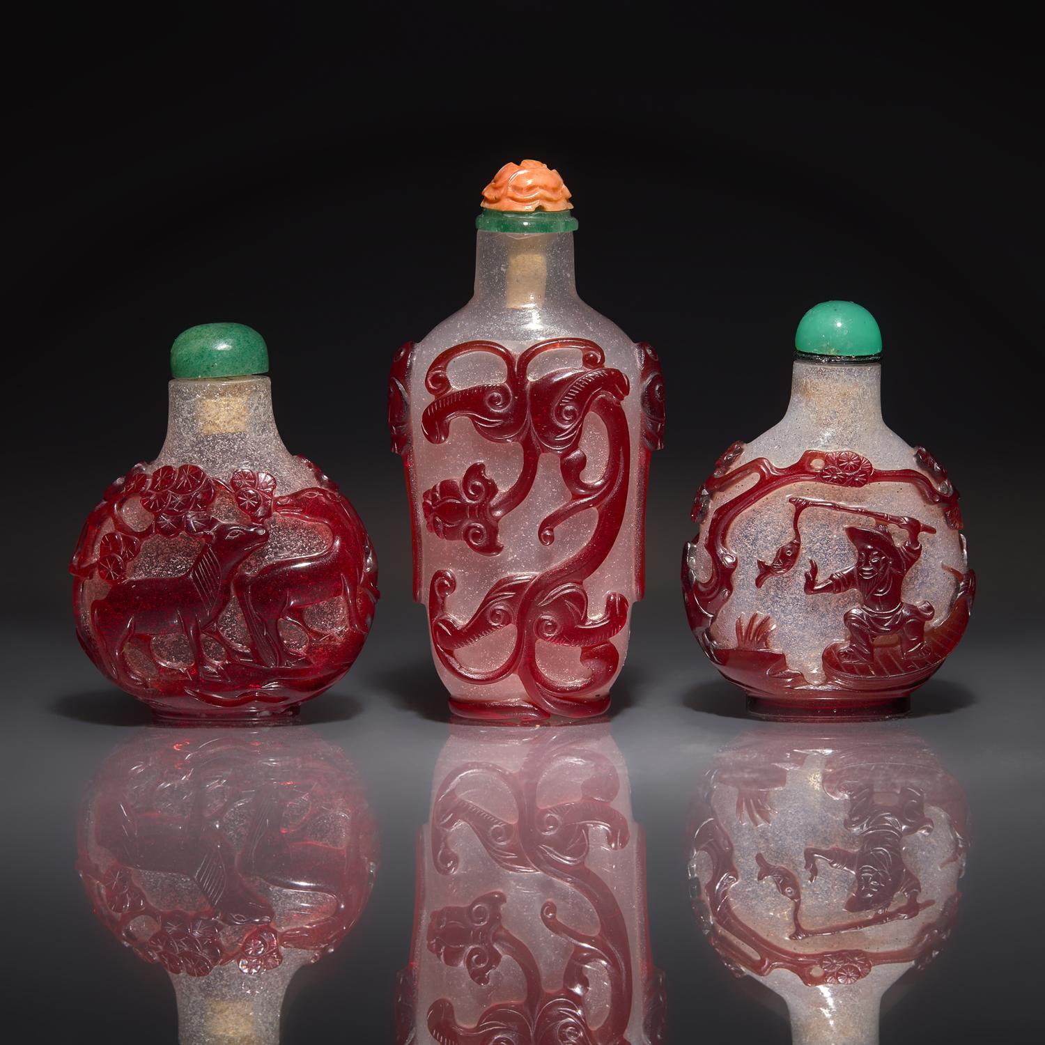 Three Chinese Ruby-Overlay Glass Snuff Bottles, 18th-19th Century — 清中期 雪霏地套寶石紅料鼻烟壺三支