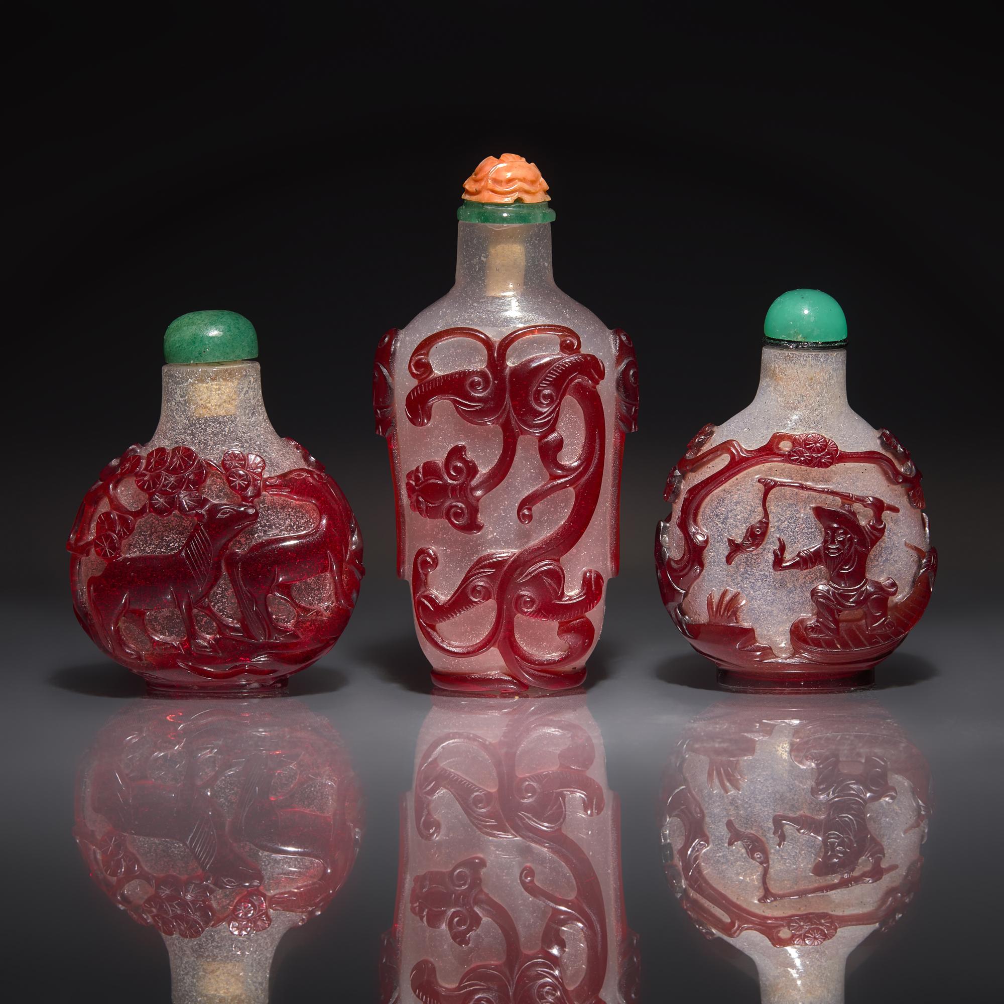 Three Chinese Ruby-Overlay Glass Snuff Bottles, 18th-19th Century — 清中期 雪霏地套寶石紅料鼻烟壺三支