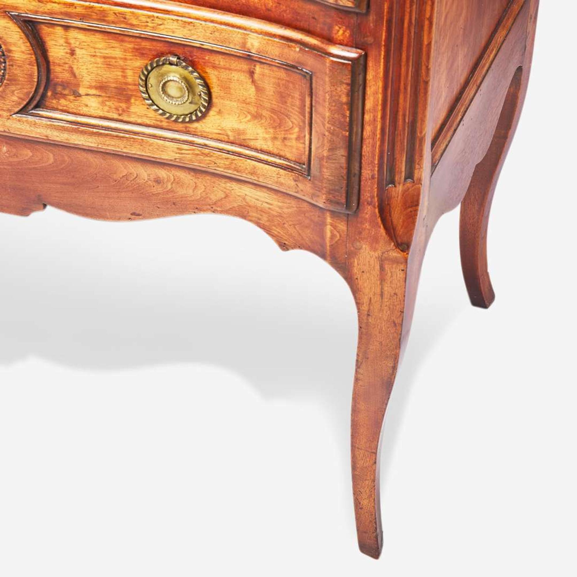 A French Directoire carved walnut commode circa 1800