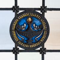 Window with cast metal lamp in circular medallion