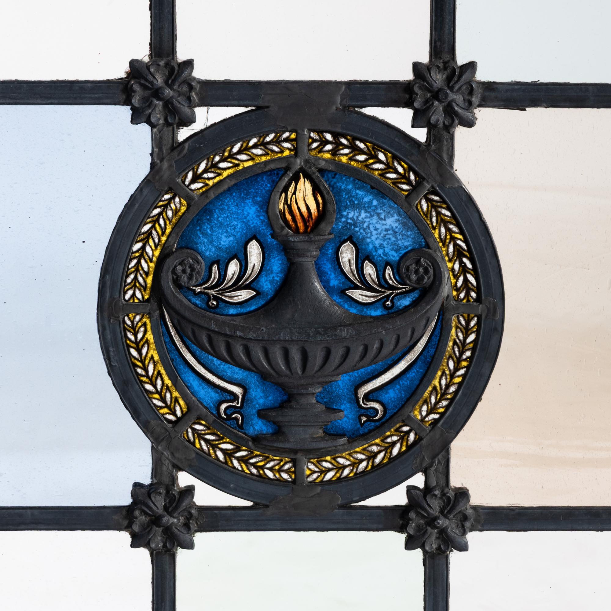 Window with cast metal lamp in circular medallion