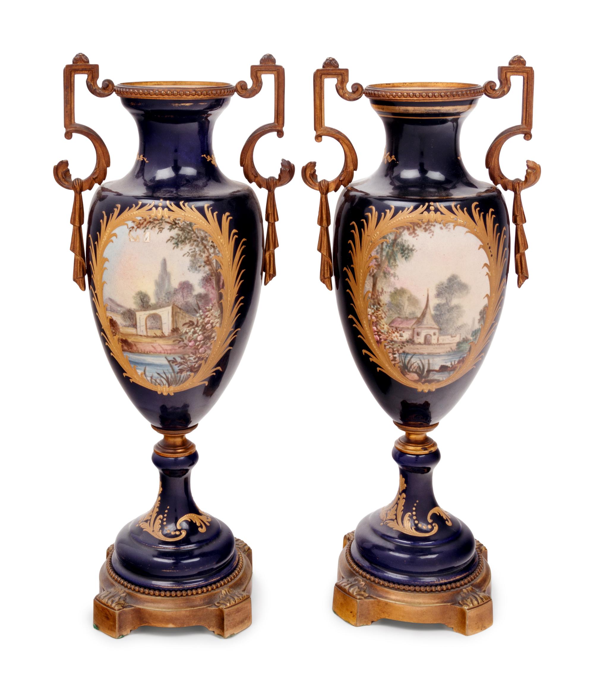 A Pair of Sèvres Style Gilt Bronze Mounted Porcelain Urns