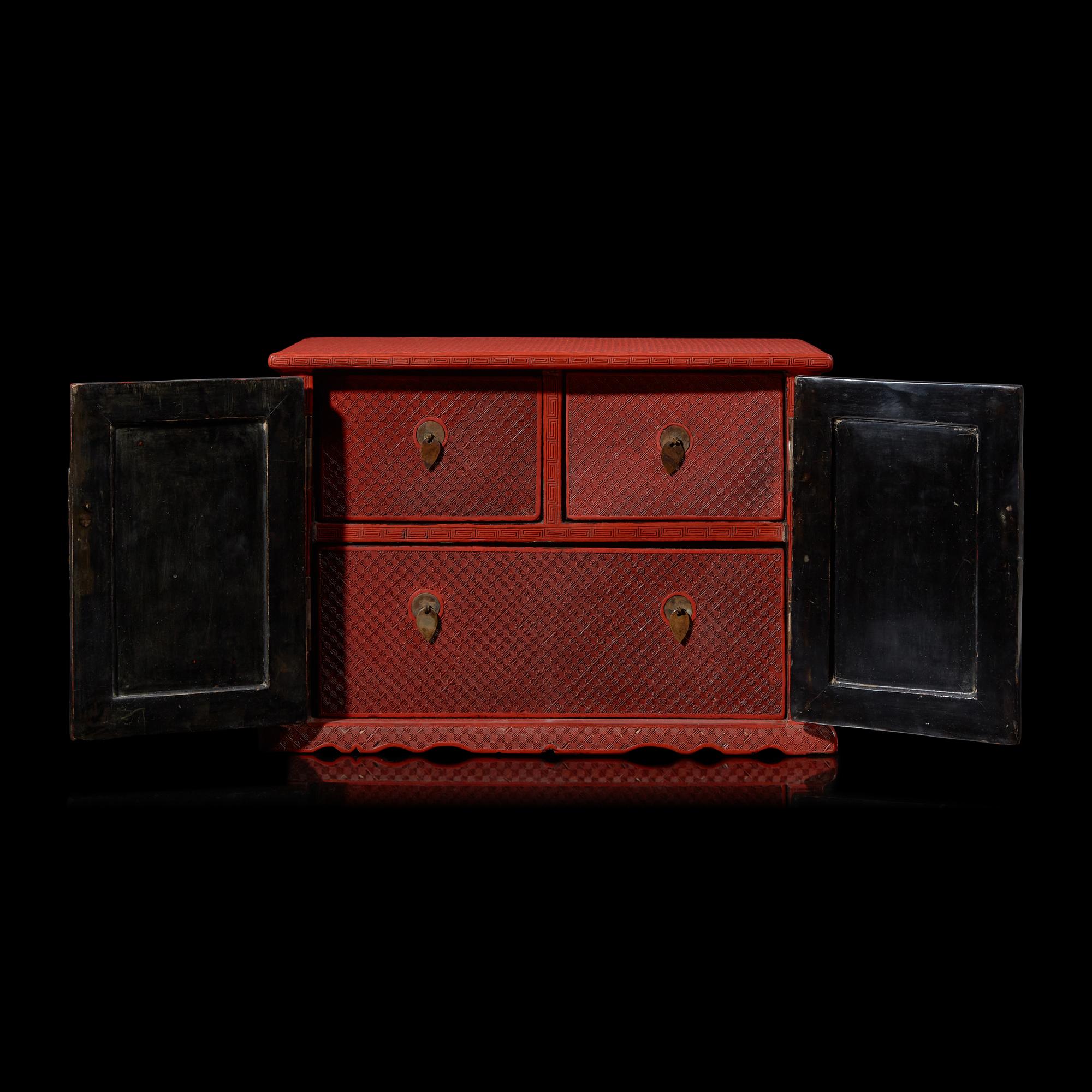 A Chinese Carved Cinnabar Lacquer Two-Door Small Cabinet, Late 19th/20th Century 清末民國 剔紅百寶箱