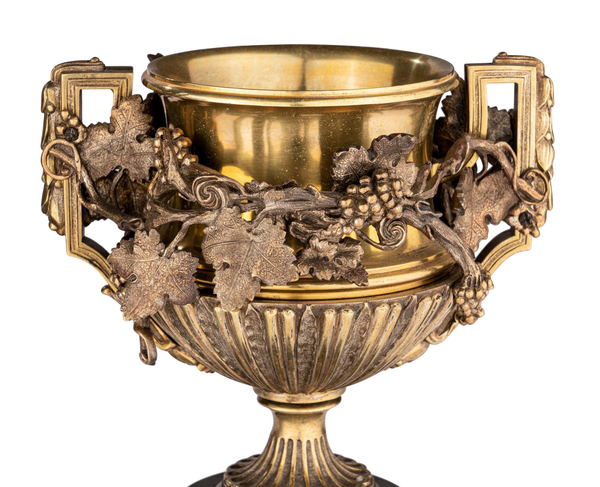 A Pair of Continental Gilt Bronze Urns on Slate Plinths
