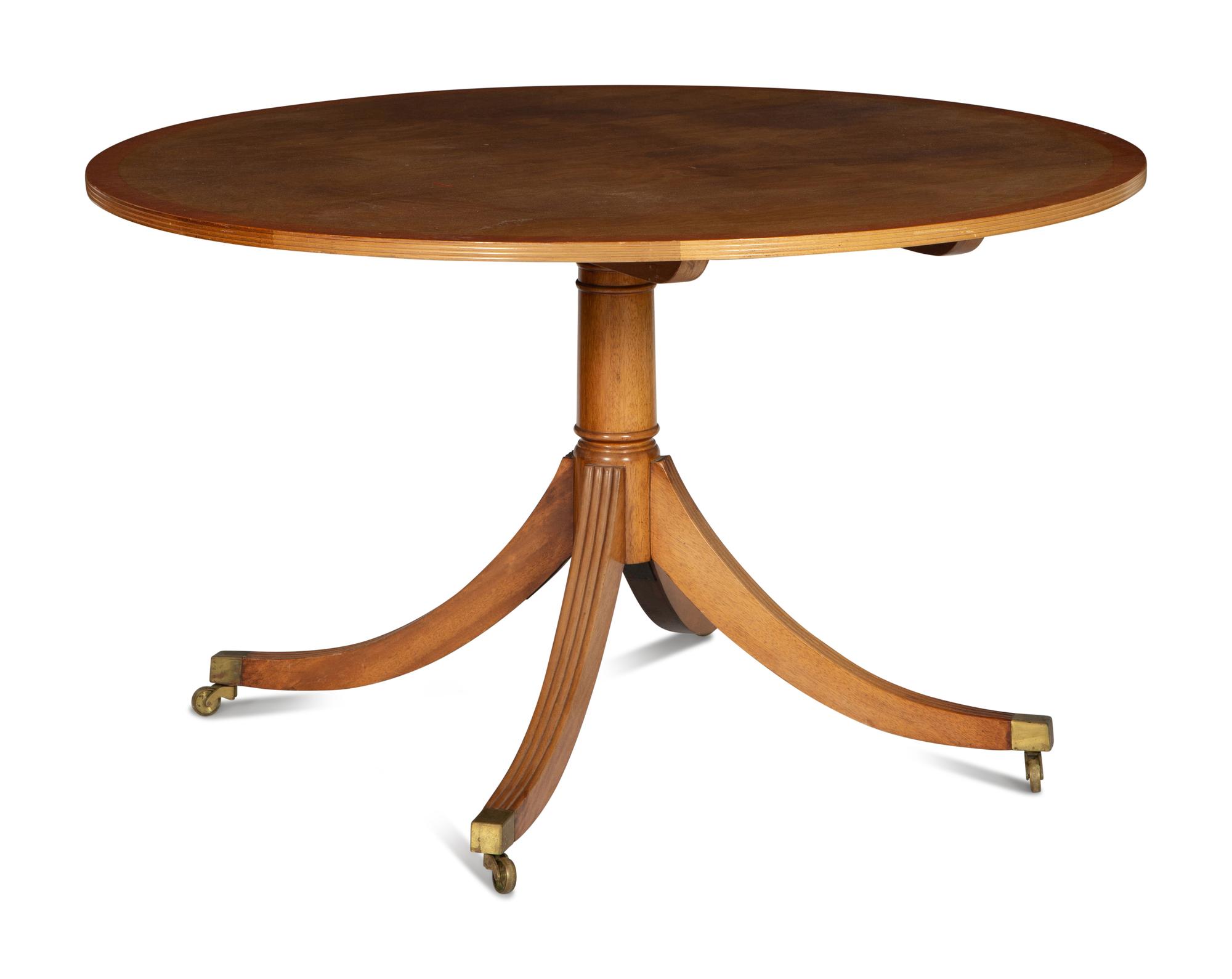 A Regency Style Cross Banded Walnut Top Pedestal Base Breakfast Table